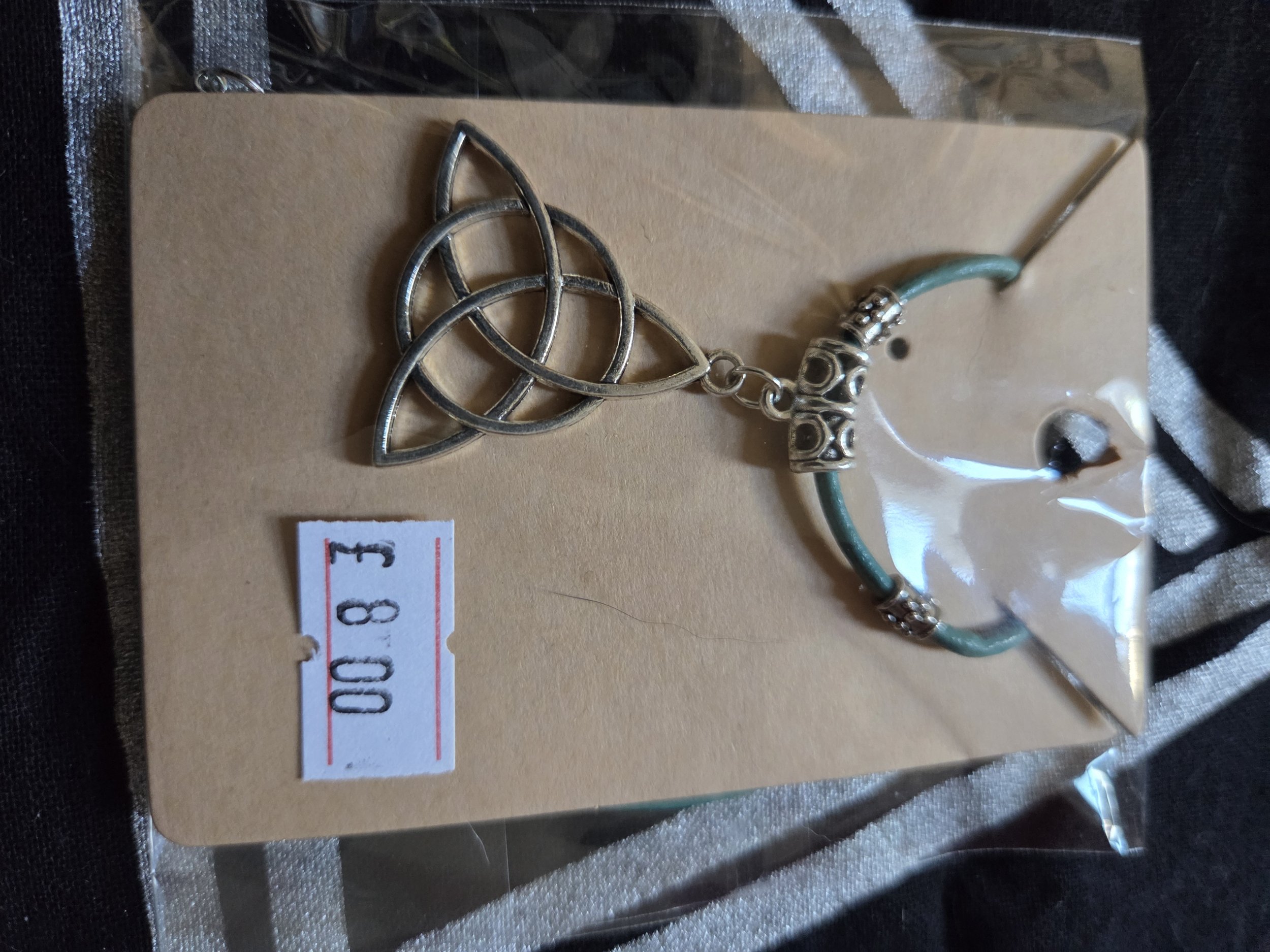 Charm pendant with green leather cord