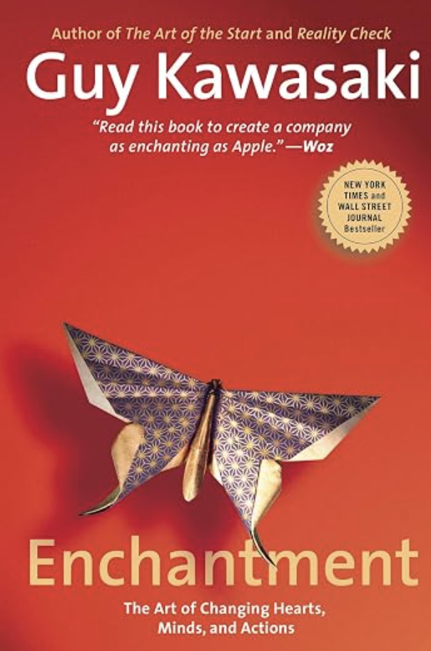 The cover of the book titled "Enchantment" by Guy Kawasaki, featuring a paper butterfly origami on a red background and a gold badge indicating it is a New York Times and Wall Street Journal bestseller.