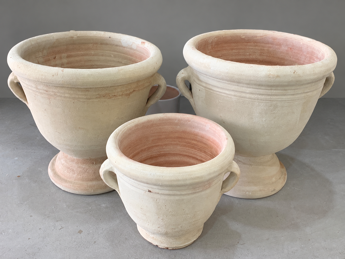 Rustic Terracotta Urns on Gray Floor.png