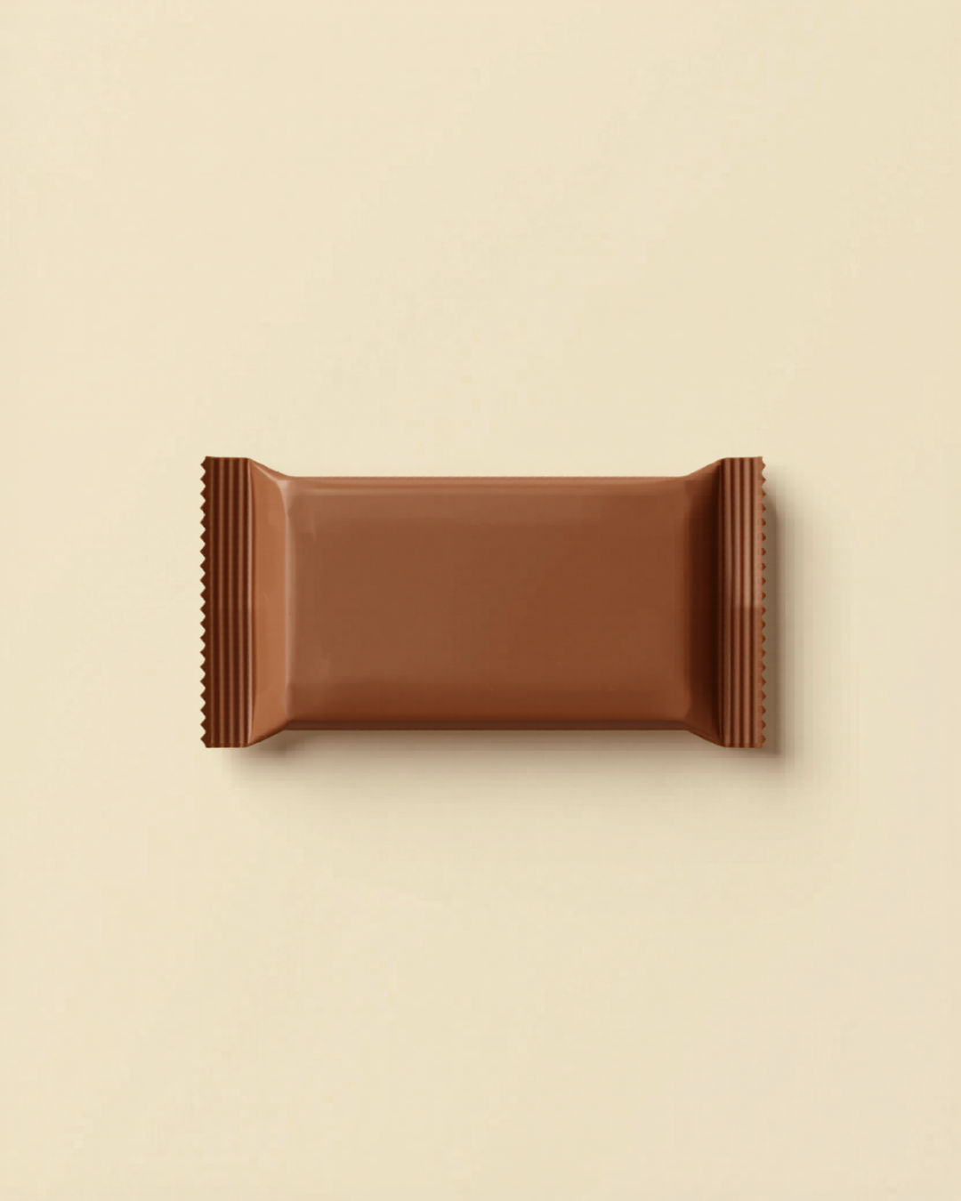Unwrapped chocolate or muesli bar on a light background.