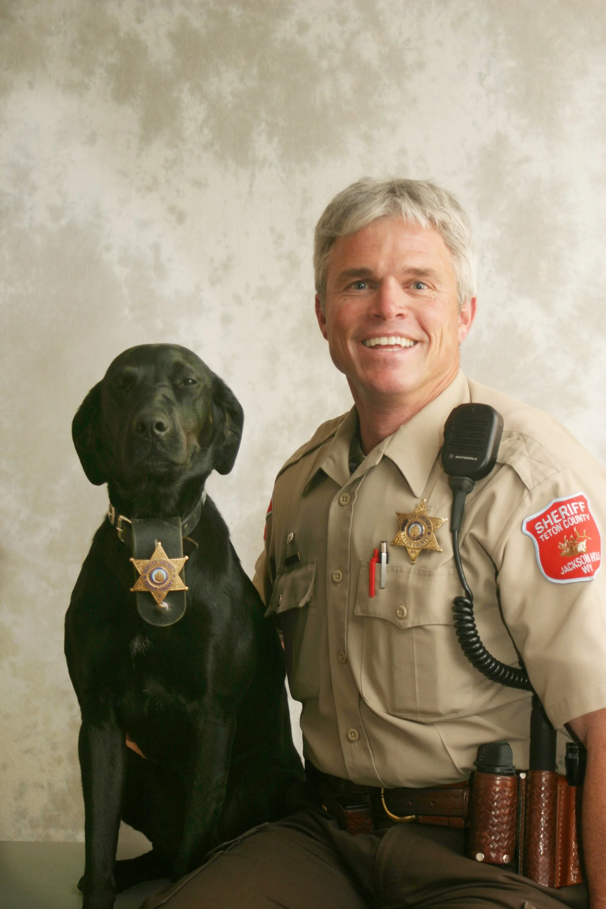 Dave Hodges, Democratic candidate for Teton County Coroner, in his Sheriff's Deputy uniform alongside K9 police dog, Pepper, his loyal companion.