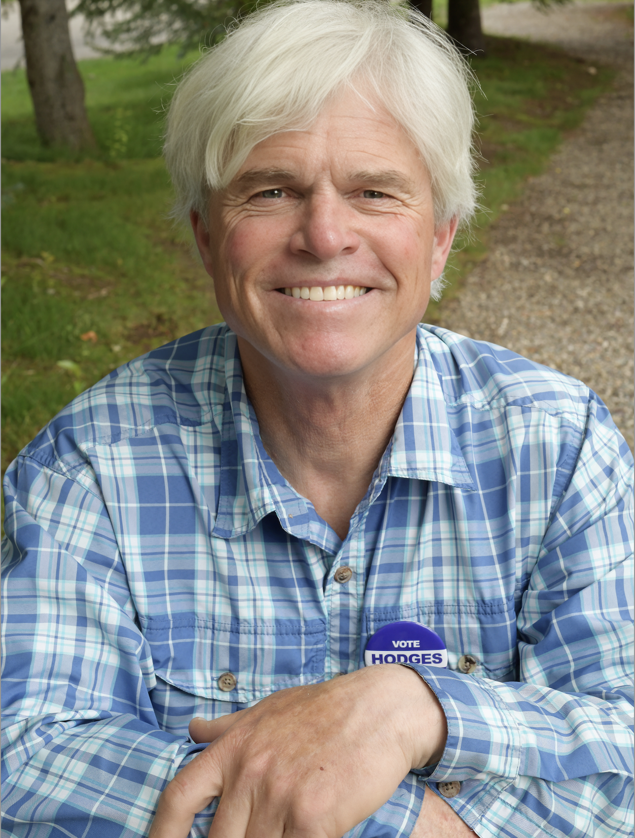 Dave Hodges in a blue button up, sporting a Vote Hodges Coroner button