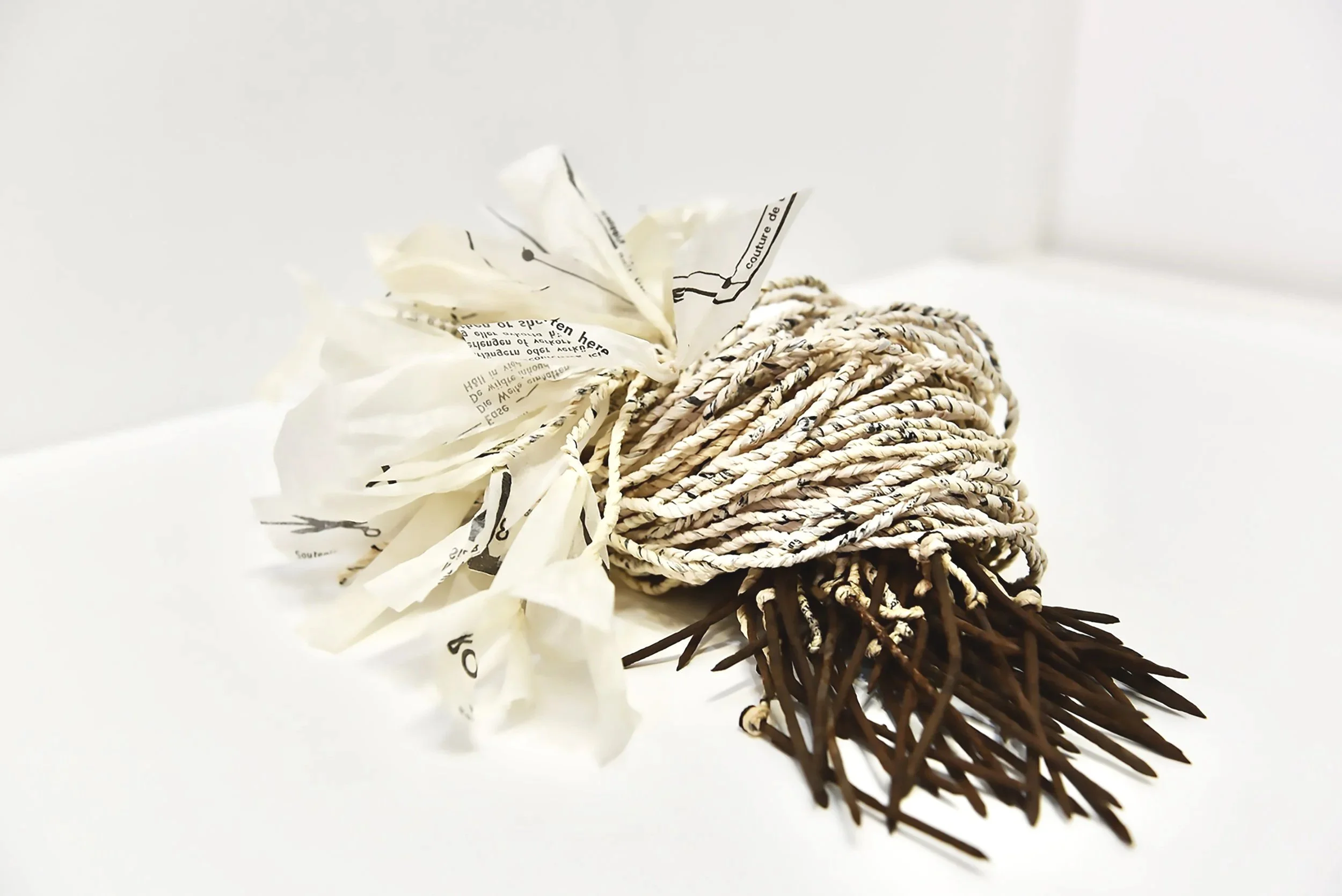 Best Laid Plans II, 2022. Vintage paper sewing patterns, found nails, cotton and glue, 18 x 35 x 25cm
