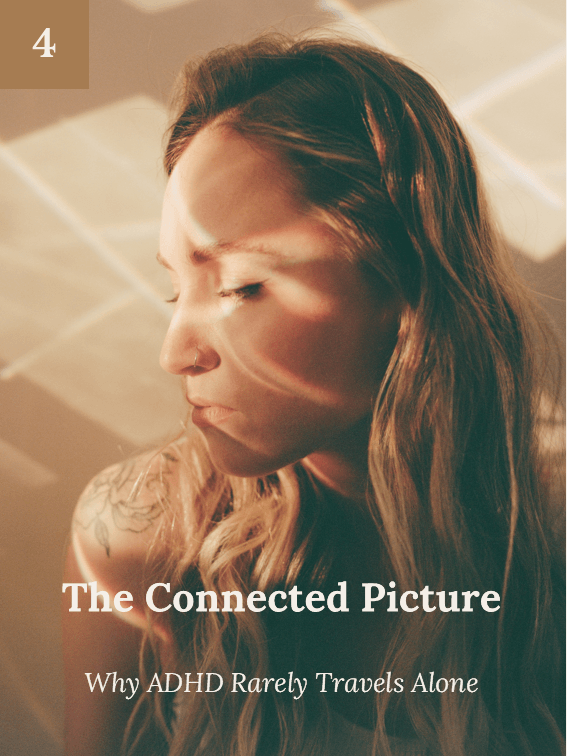 A young woman with long hair and a nose piercing sitting with her eyes closed, illuminated by soft, warm light, creating a contemplative mood.