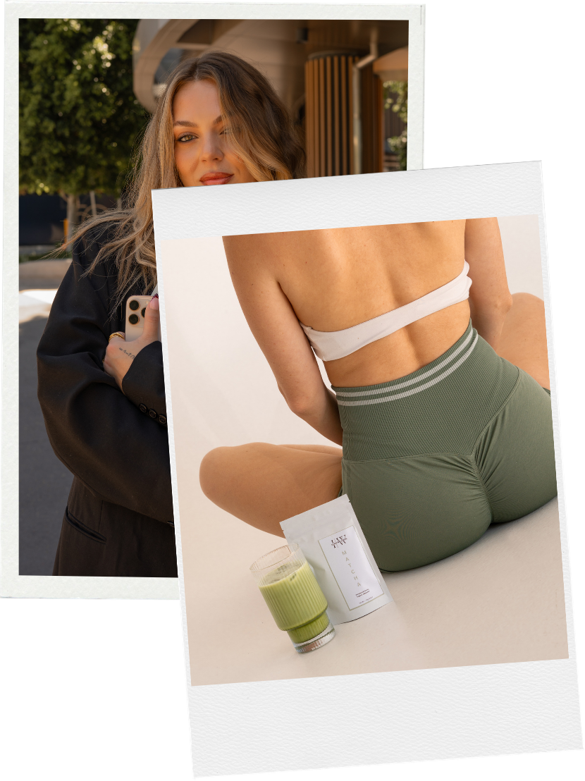 A woman sitting on a white surface with a cup of green smoothie, a box of dietary supplement, and a packet of powder nearby, dressed in a white crop top and green shorts.