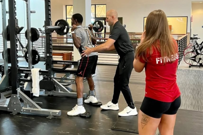 Matthew Carney providing personal training at the gym