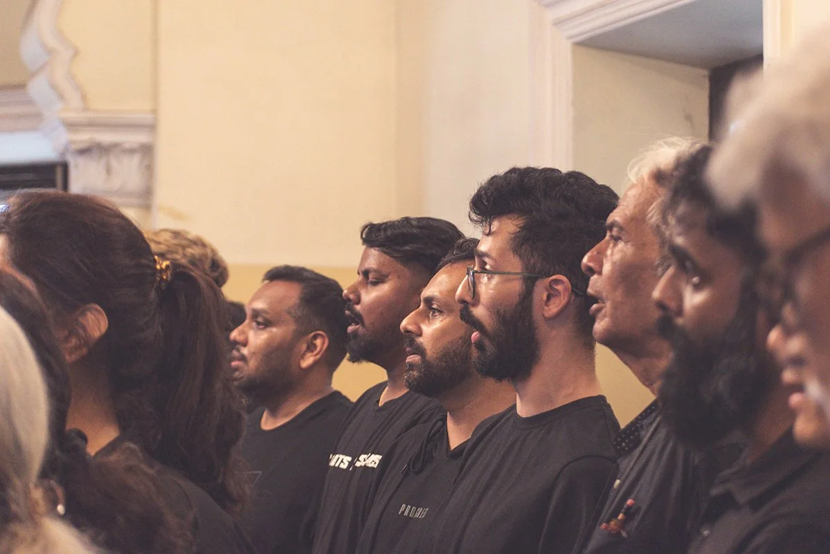 People standing in a row, paying attention during an event