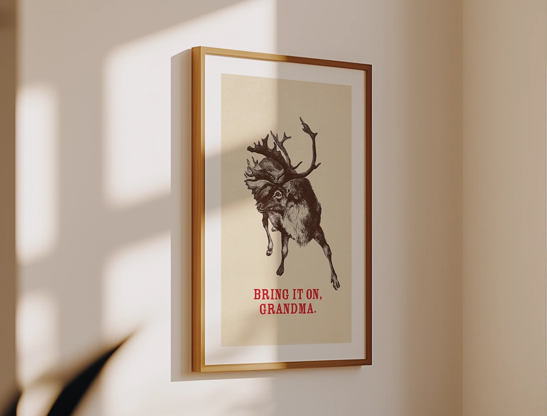 Framed vintage-style poster of a reindeer with the text “Bring it on, Grandma.”