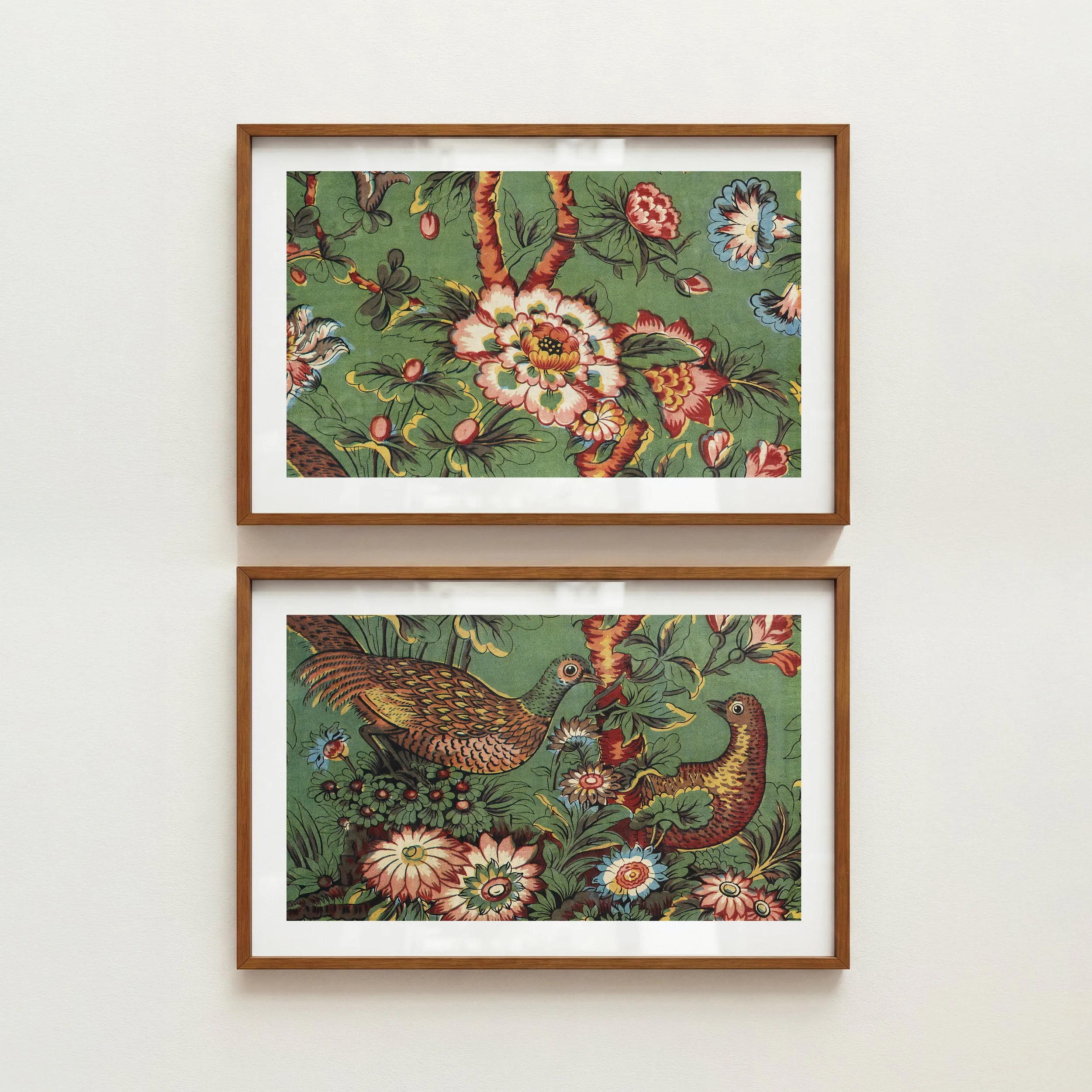A framed painting of a colorful bird and flowers on a green background, displayed on a plain white wall.