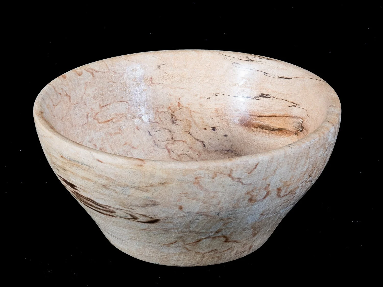 A marble bowl with a beige and brown swirling pattern against a black background.