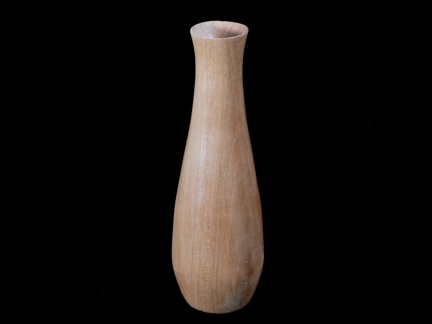 A wooden vase with a narrow base that widens into a rounded middle and tapers slightly at the top, placed against a black background.