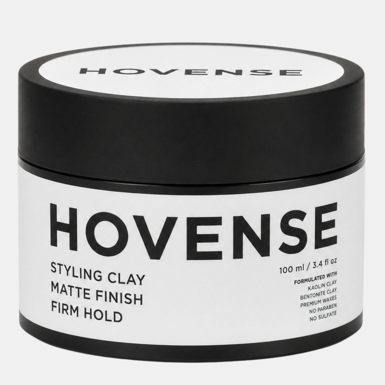 A round container of Hovense styling clay with a black lid and white label, featuring bold black text detailing product features like matte finish and firm hold.