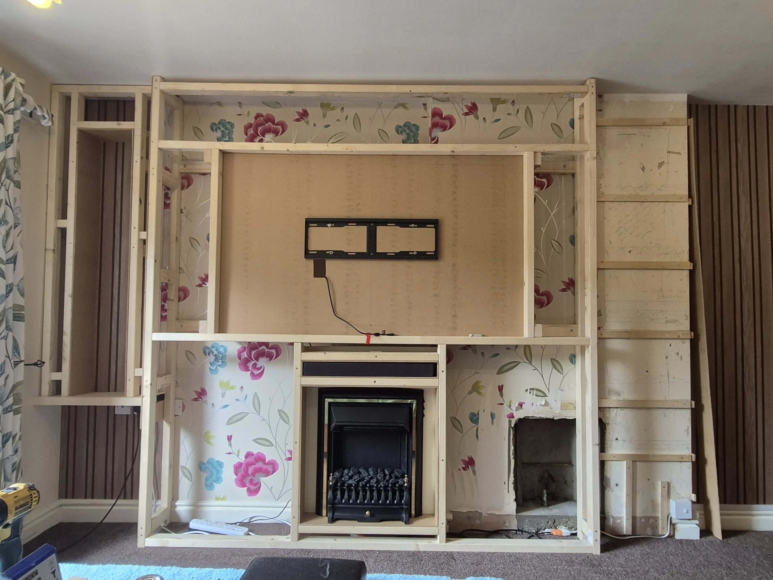 Most frame work up at this stage and bolted to the wall. Tv recess, sound bar and fire in place.