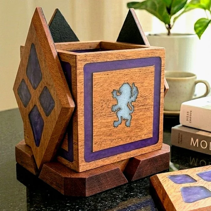 Decorative wooden box with a lion symbol on the front, placed on a table near books and a potted plant.