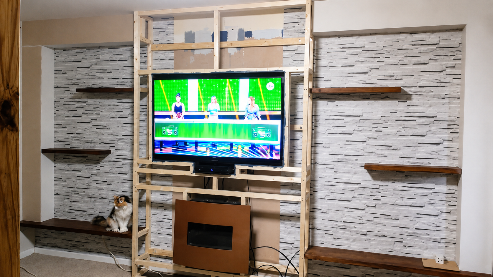 Alcove cladding done walnut floating shelfs added. Owners cat inspecting the work.