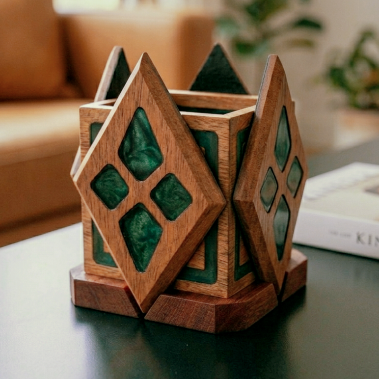 Decorative wooden container with diamond-shaped panels and green inlaid tiles, on a table near a book and a sofa in the background.