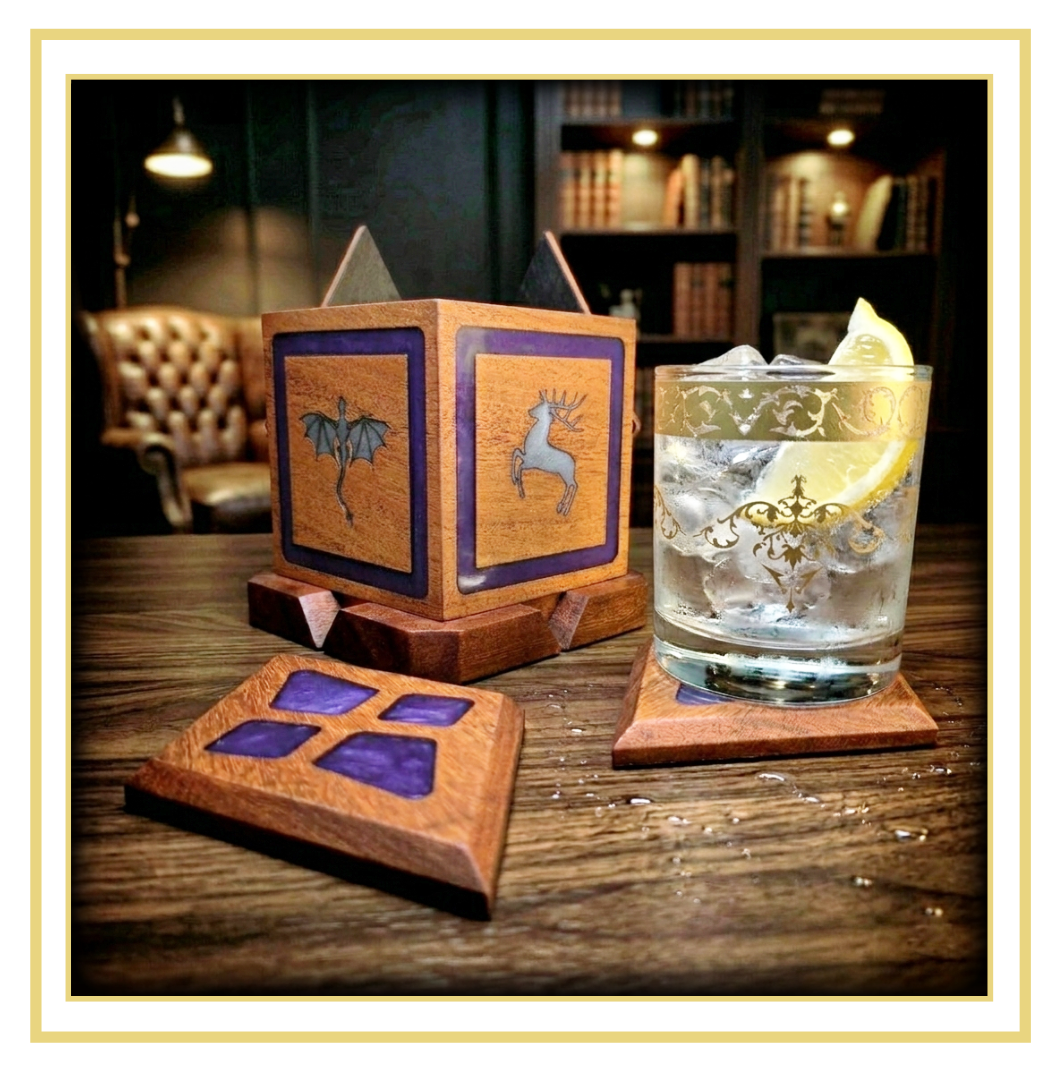 A four piece Wooden Monolith coaster set featuring a central cube-shaped holder with fantasy inspired symbols surrounded by diamond-shaped magnetic coasters with Purple resin inlays. Displayed on a table with a glass of gin and lemon.