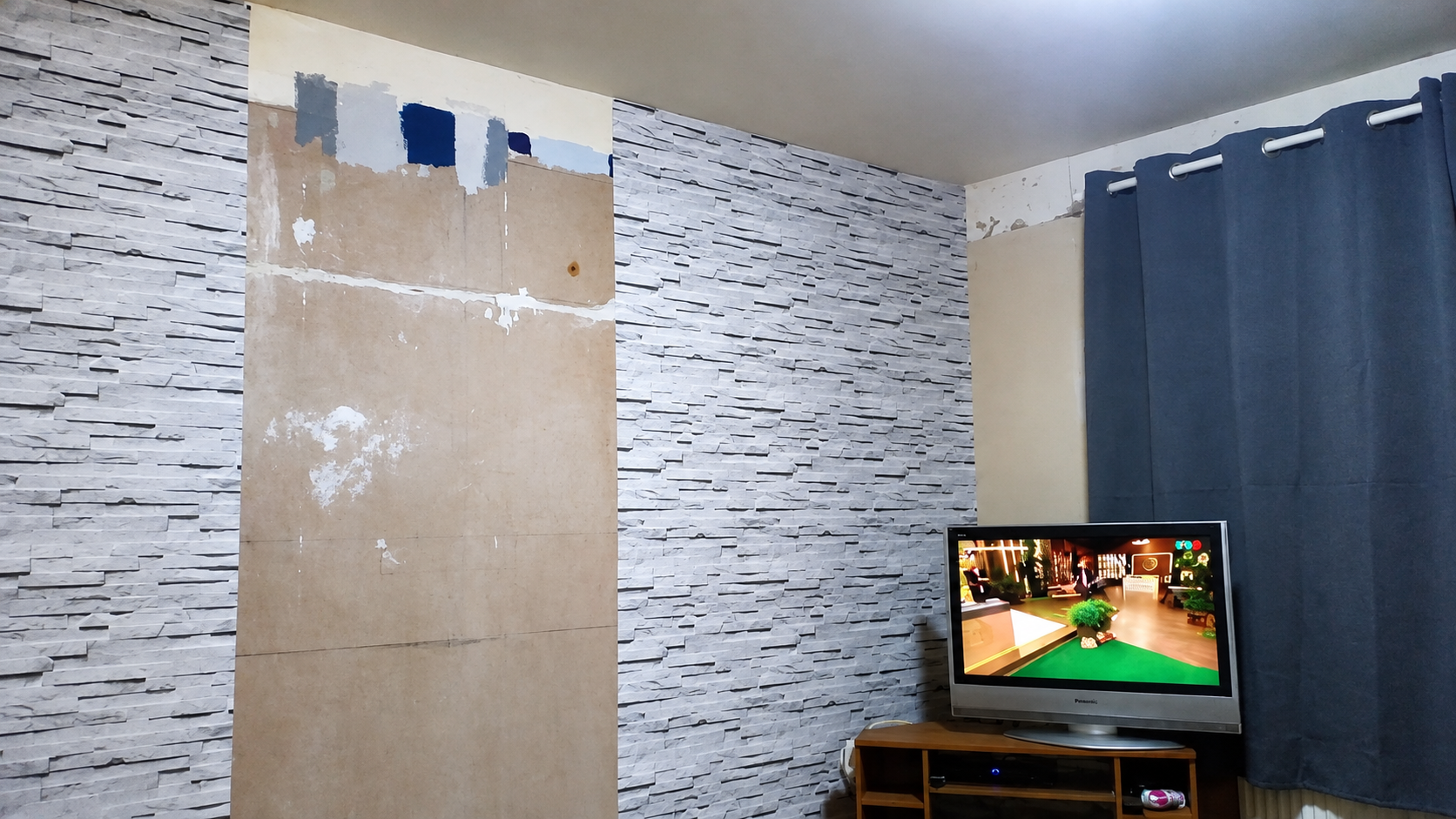Stone wall effect wall paper, wooden unit removed.