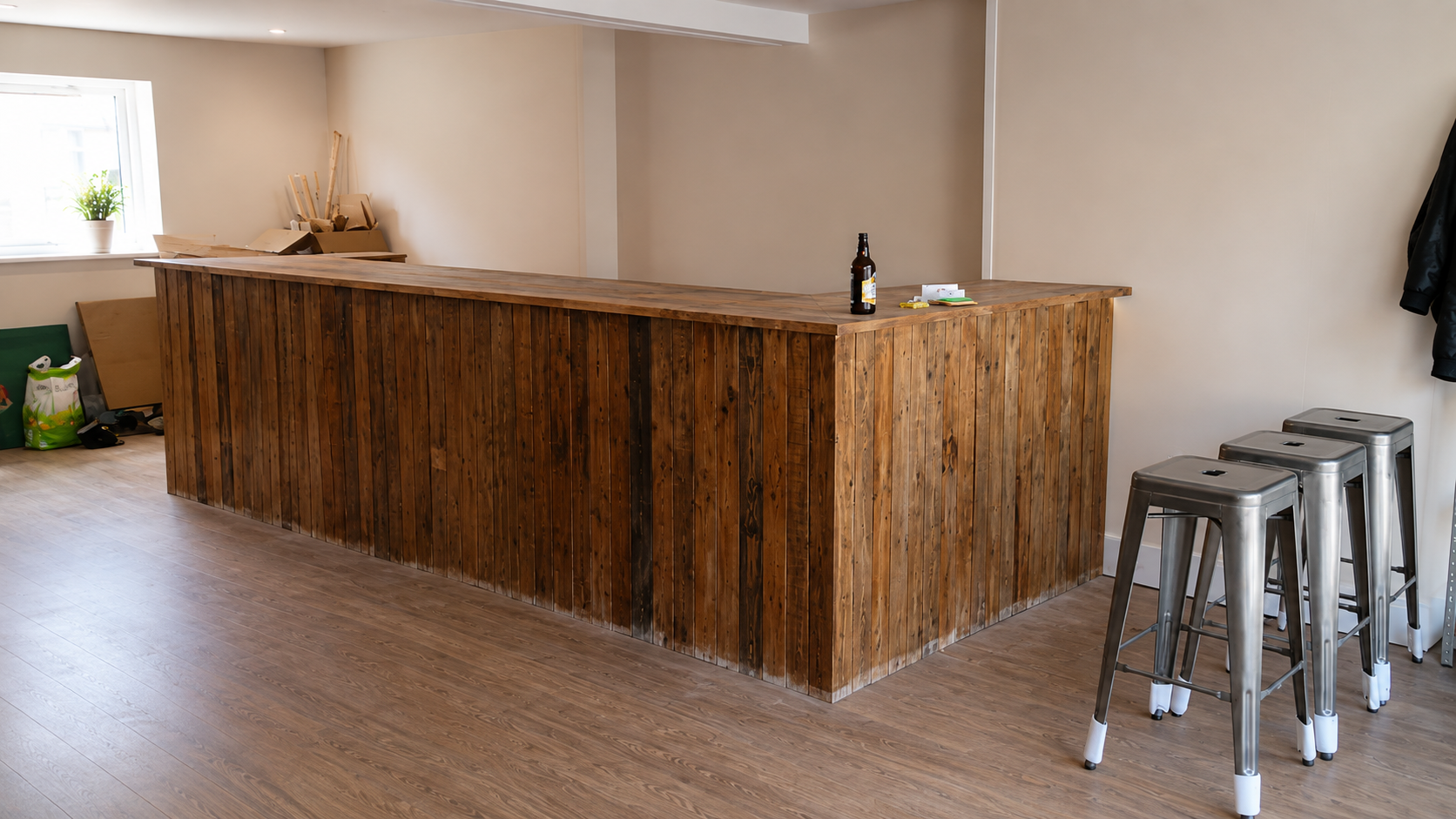 Early build and decoration stages  To meet the budget and add to the aesthetic, the entire bar was constructed from reclaimed wooden pallets.