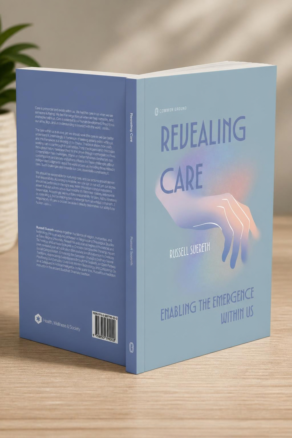 A book titled 'Revealing Care' by Russell Suereth, with a light blue cover featuring an illustration of a hand and subtitle 'Enabling the Emergence Within Us'.