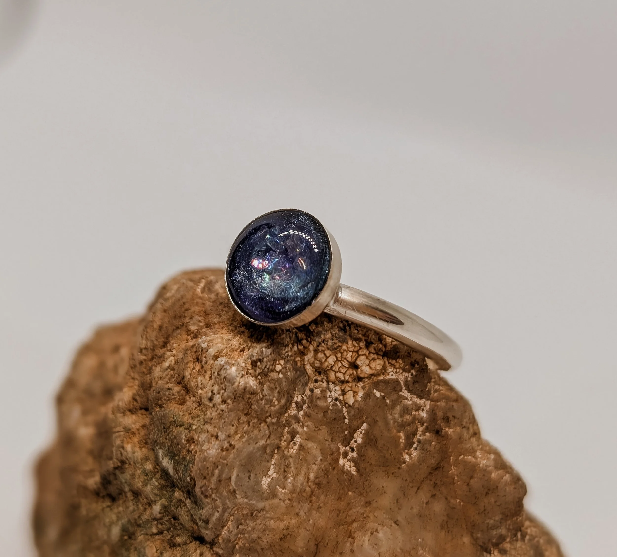 a beautiful galaxy/stardust themed ring containing cremation ashes in a wonderful timeless fashion.
