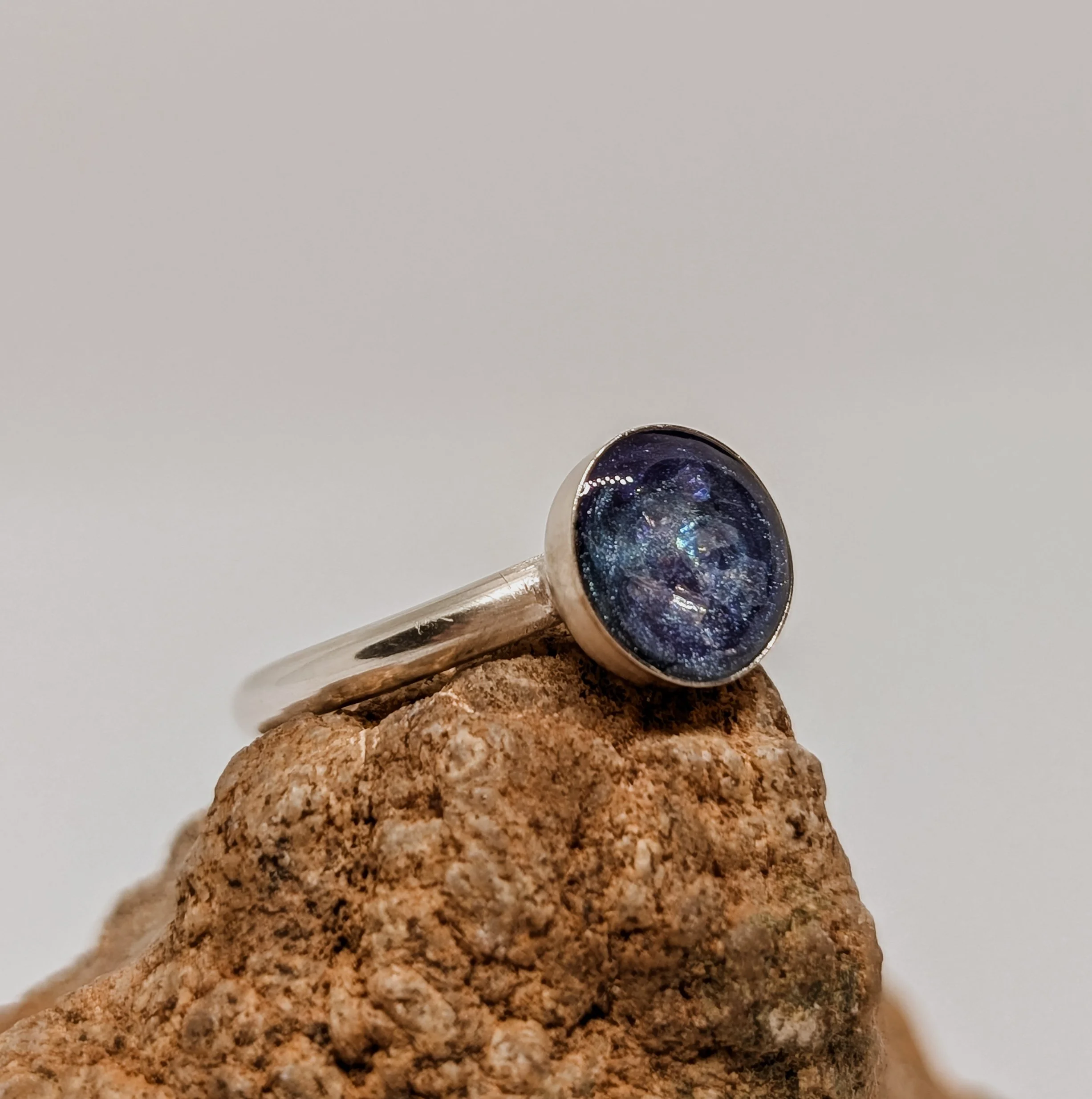a beautiful stardust/galaxy themed sterling silver ring with cremation ashes encased within.jpg