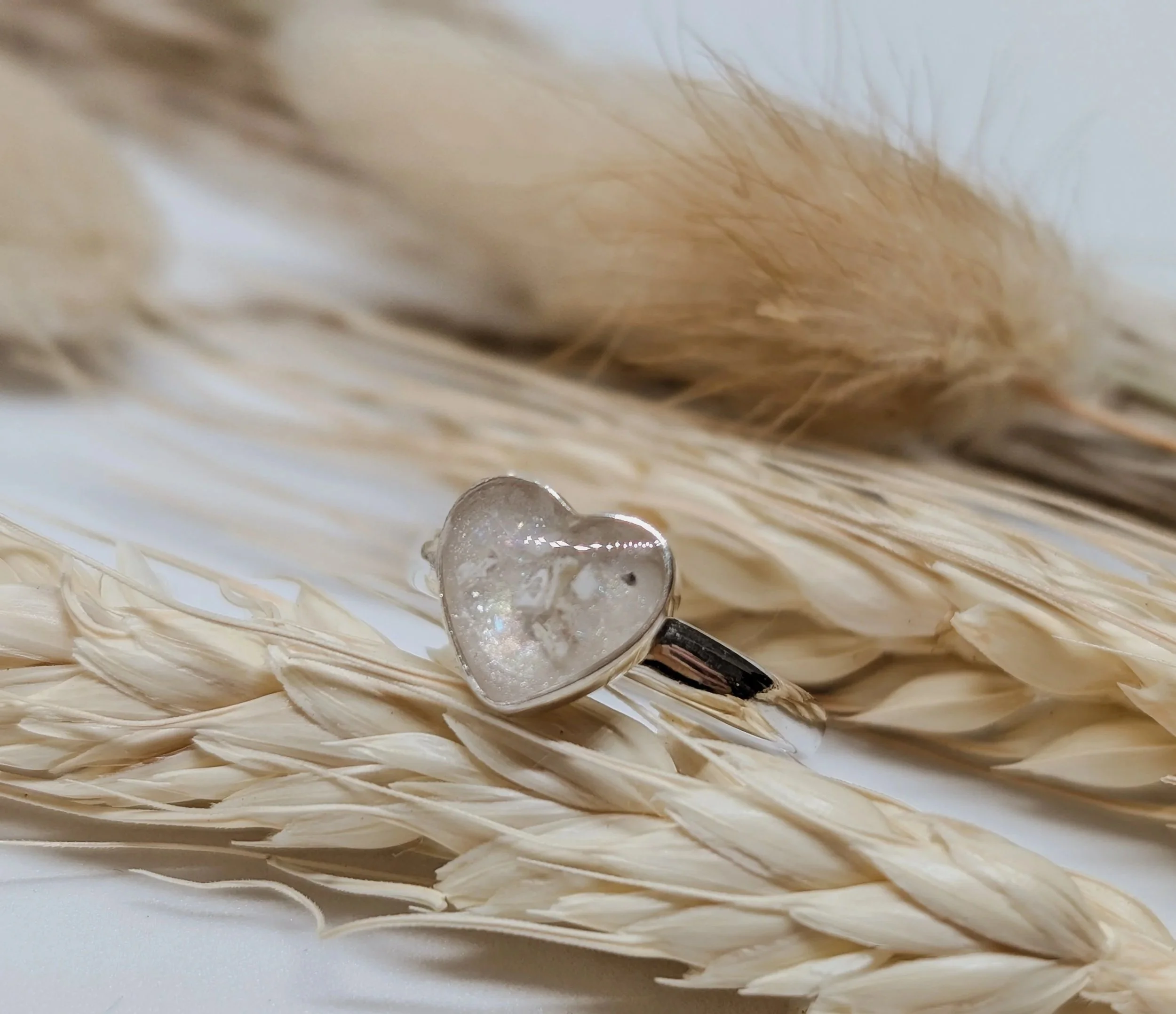 a beautiful heart shaped sterling silver ring containing cremation ashes within.jpg