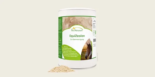 Container of EquiZeolon horse supplement with a small pile of powder in front of it.