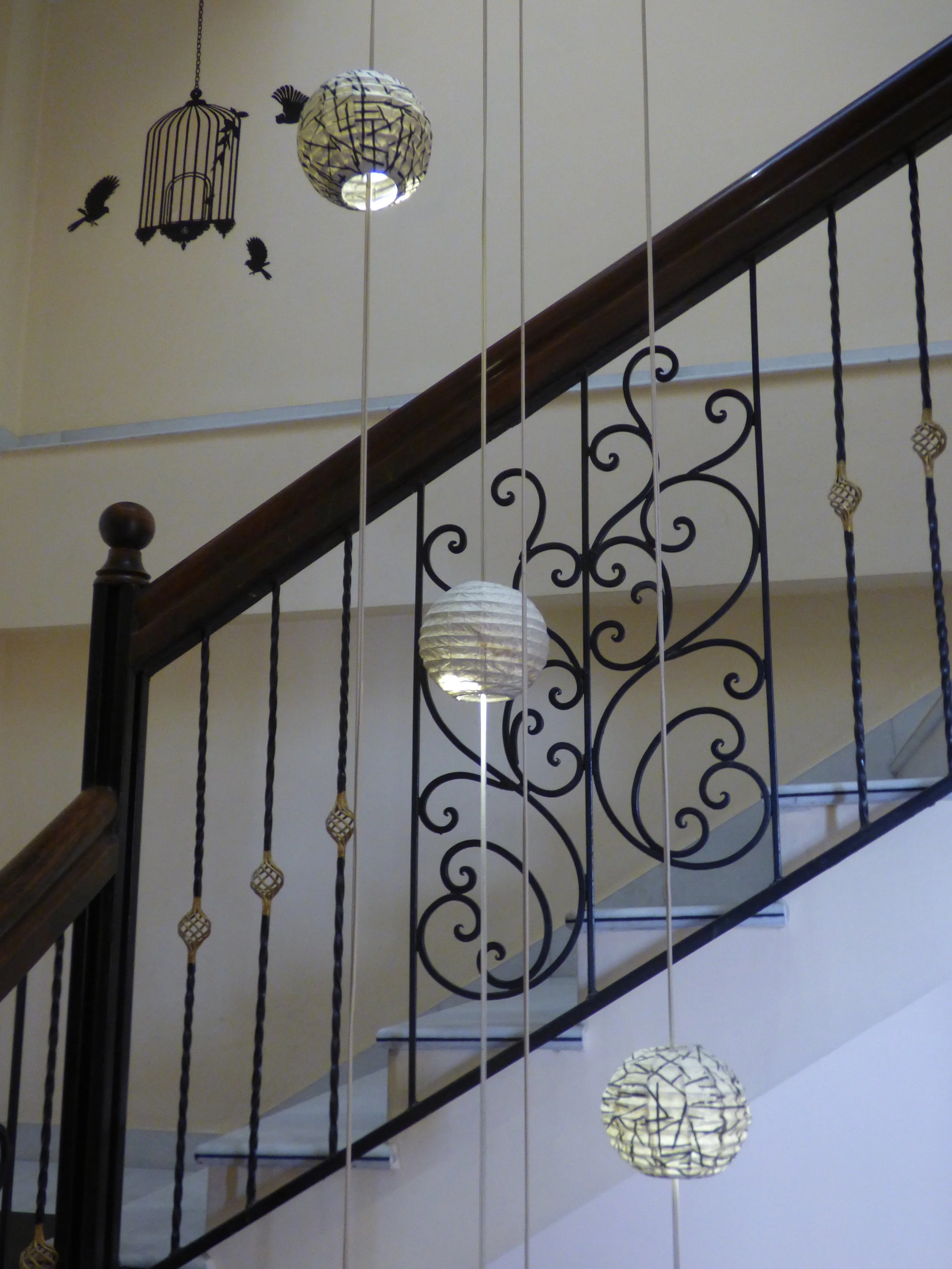 Contemplative photo by Gretchen Martens of a staircase and hanging lights in India, speaking to the Village of Care press approach to writing, editing, and publishing—professional and creative