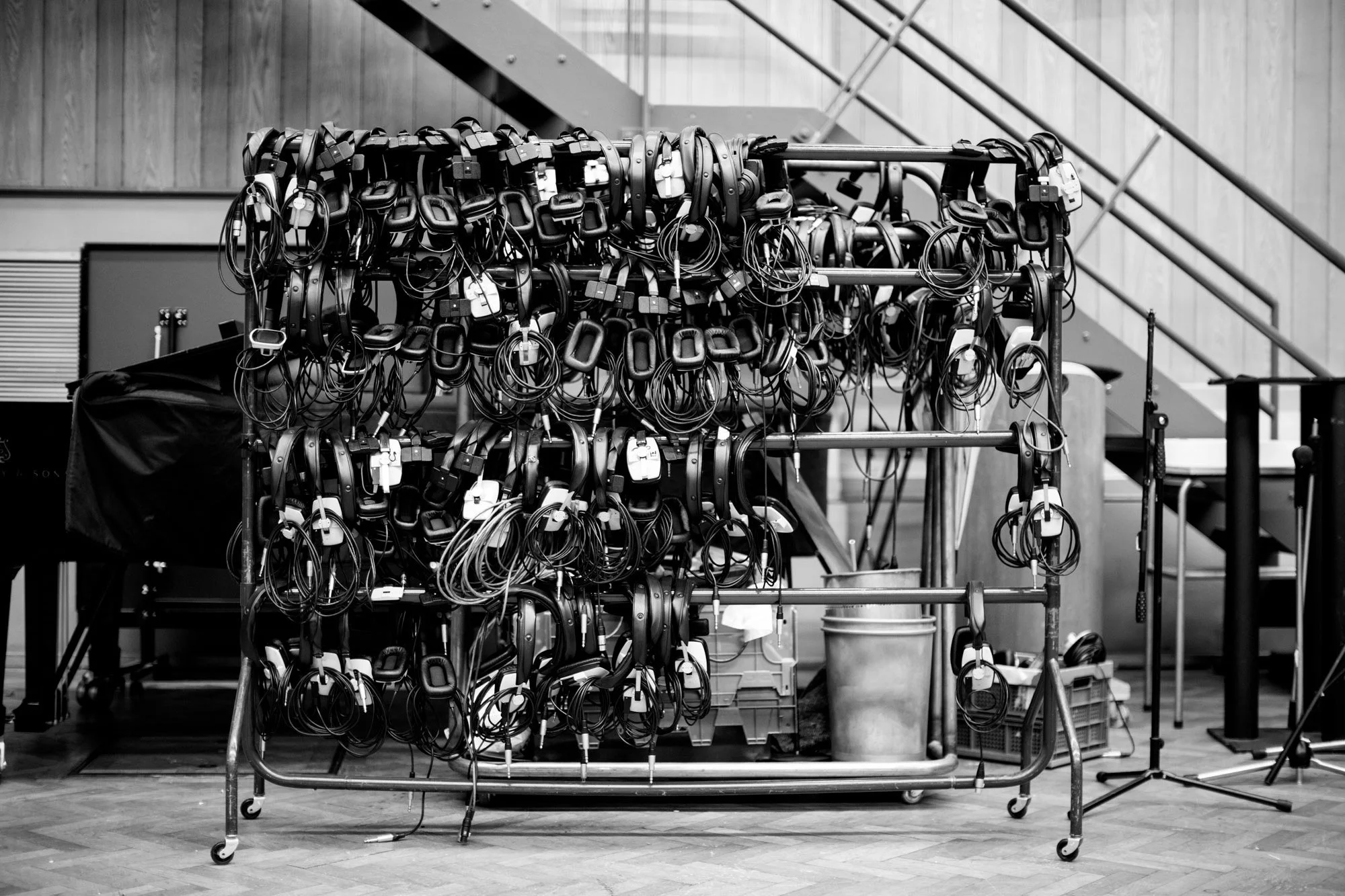 A metal cart filled with numerous headset and cable accessories in a storage or workspace environment, Abbey Road Studios, London.