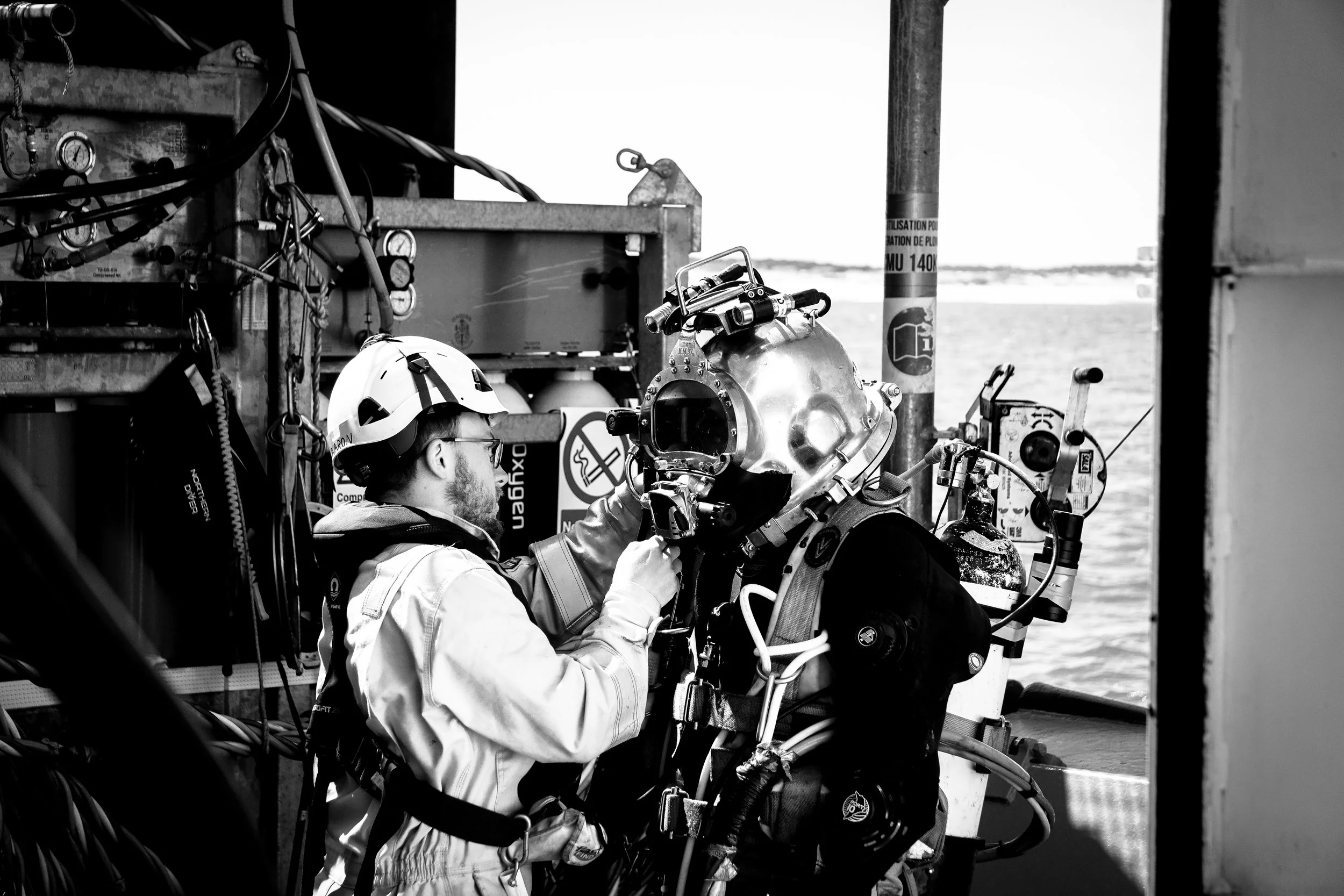 A tender dressing in a commercial diver.