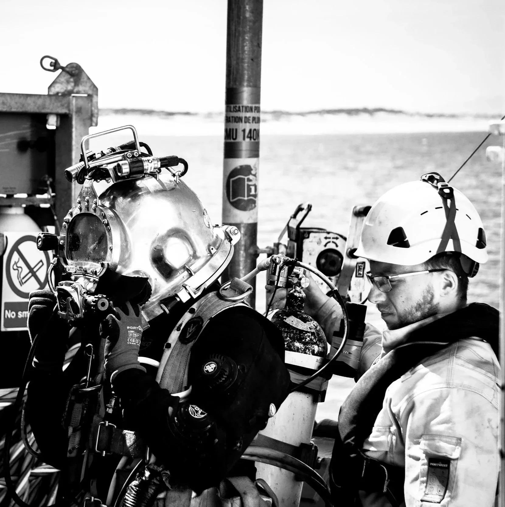 A tender dressing in a commercial diver.
