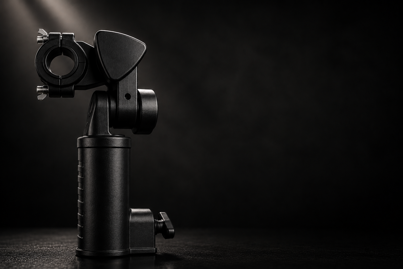 Close-up of a black camera gimbal stabilizer against a dark background.