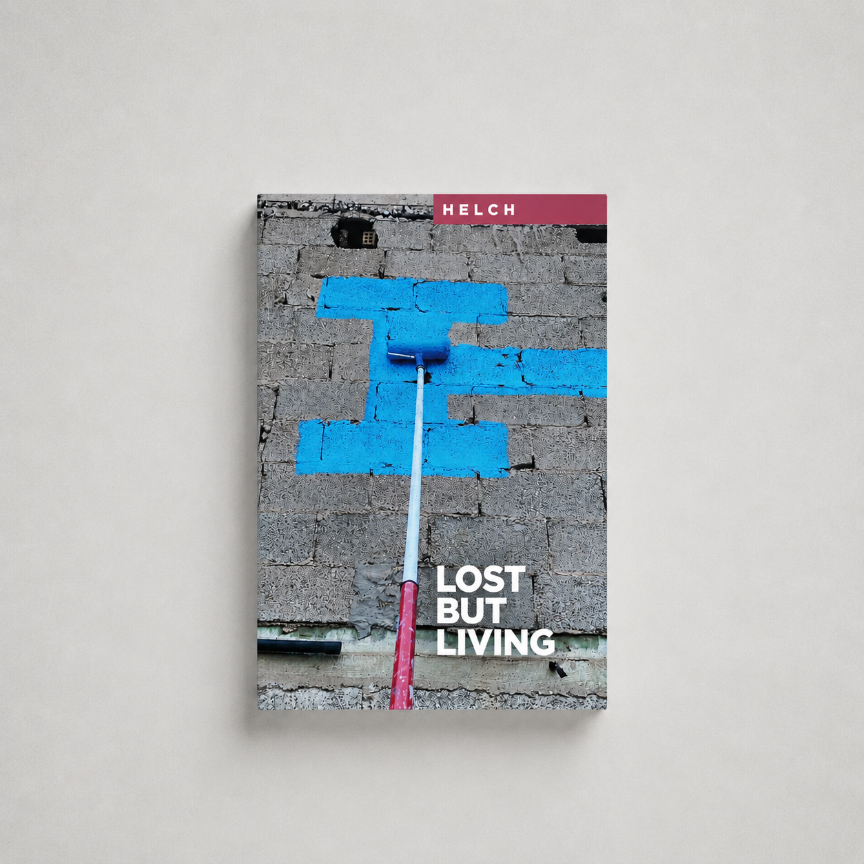 Book cover titled 'Lost but Living' featuring a wall with blue paint patches and a paint roller.