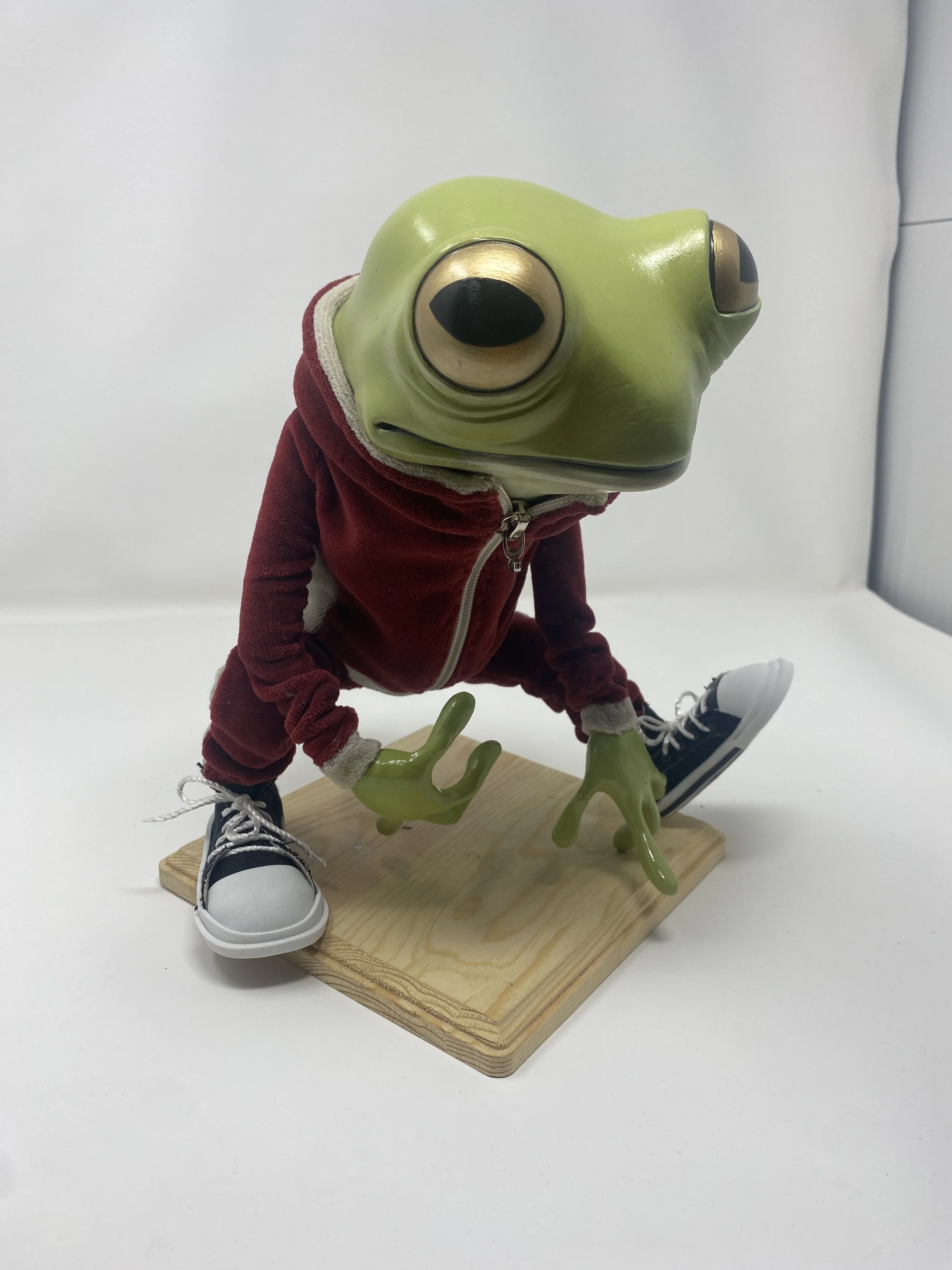 Frog in a track suit
10” tall
Fabric, wire, paperclay, acrylic paint 
2023