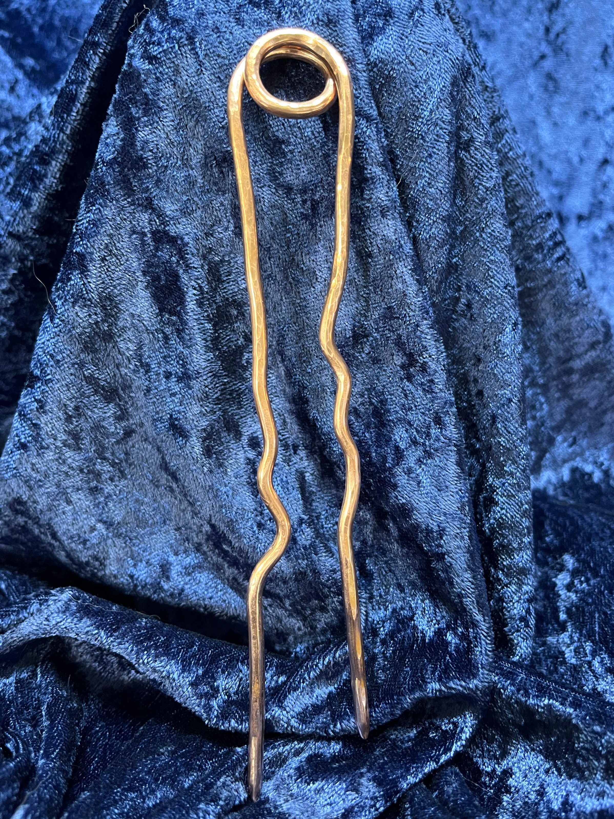 Hair stick laying on a blue background.