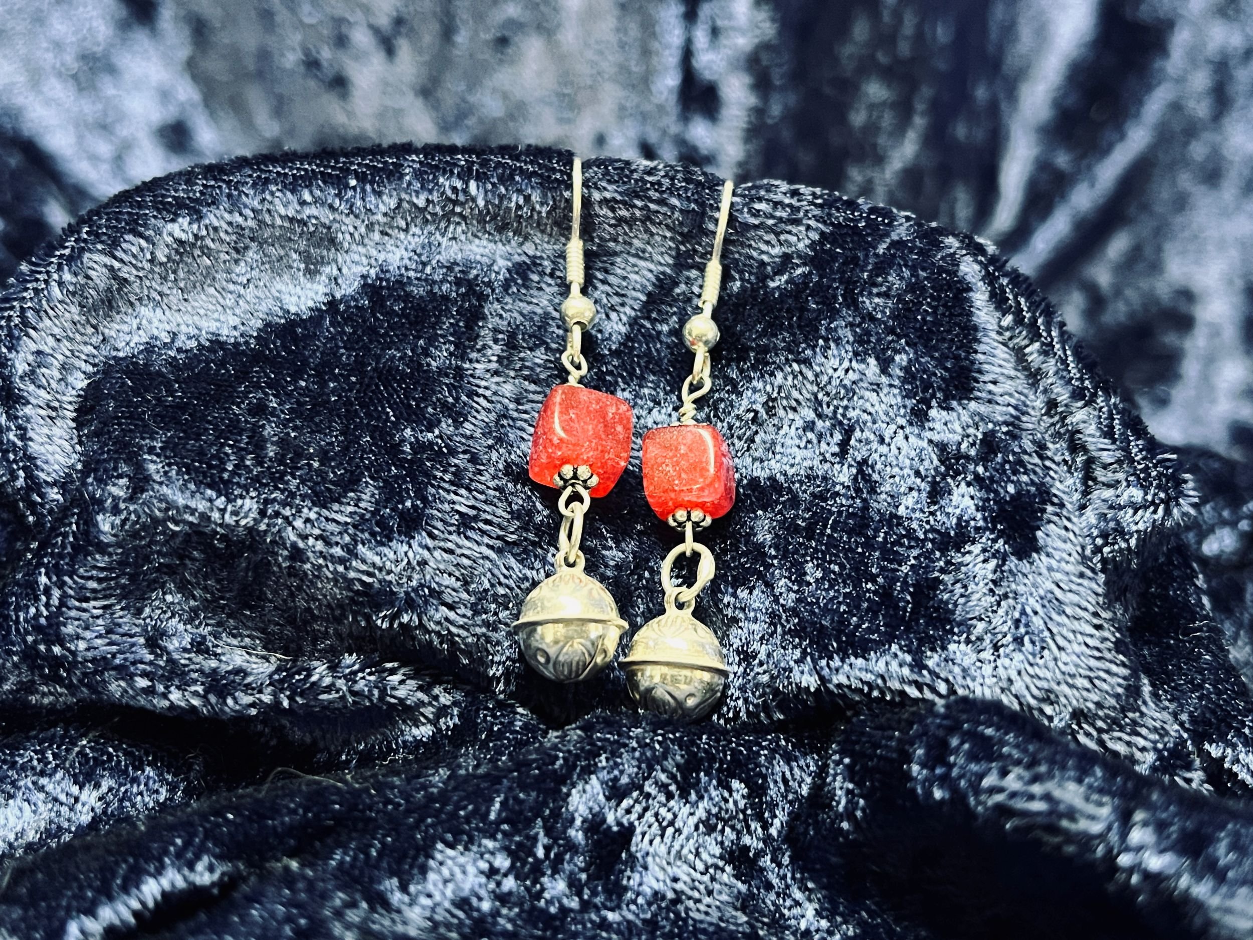 Earrings hanging on a blue background.