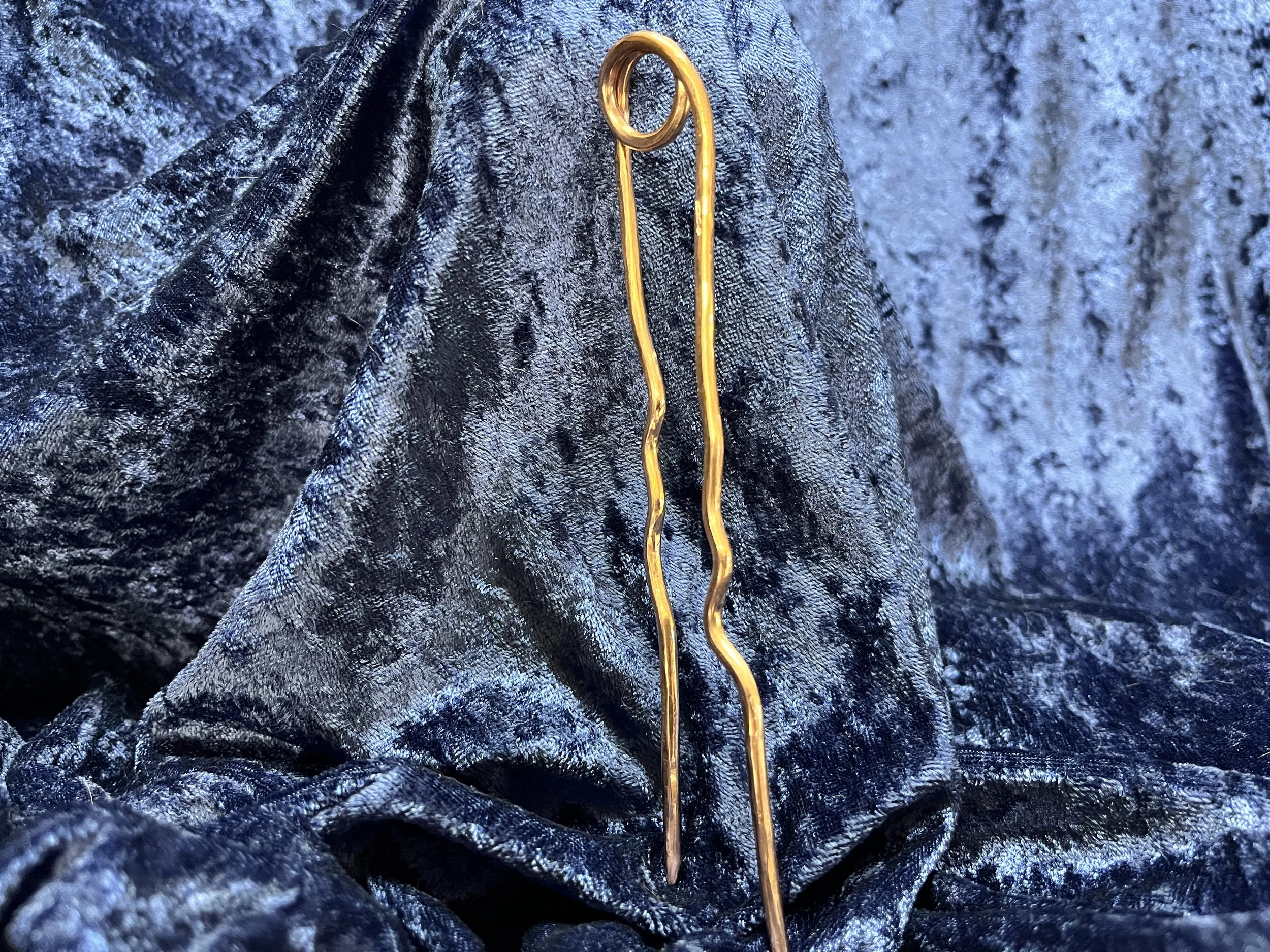 Hair stick laying on a blue background.