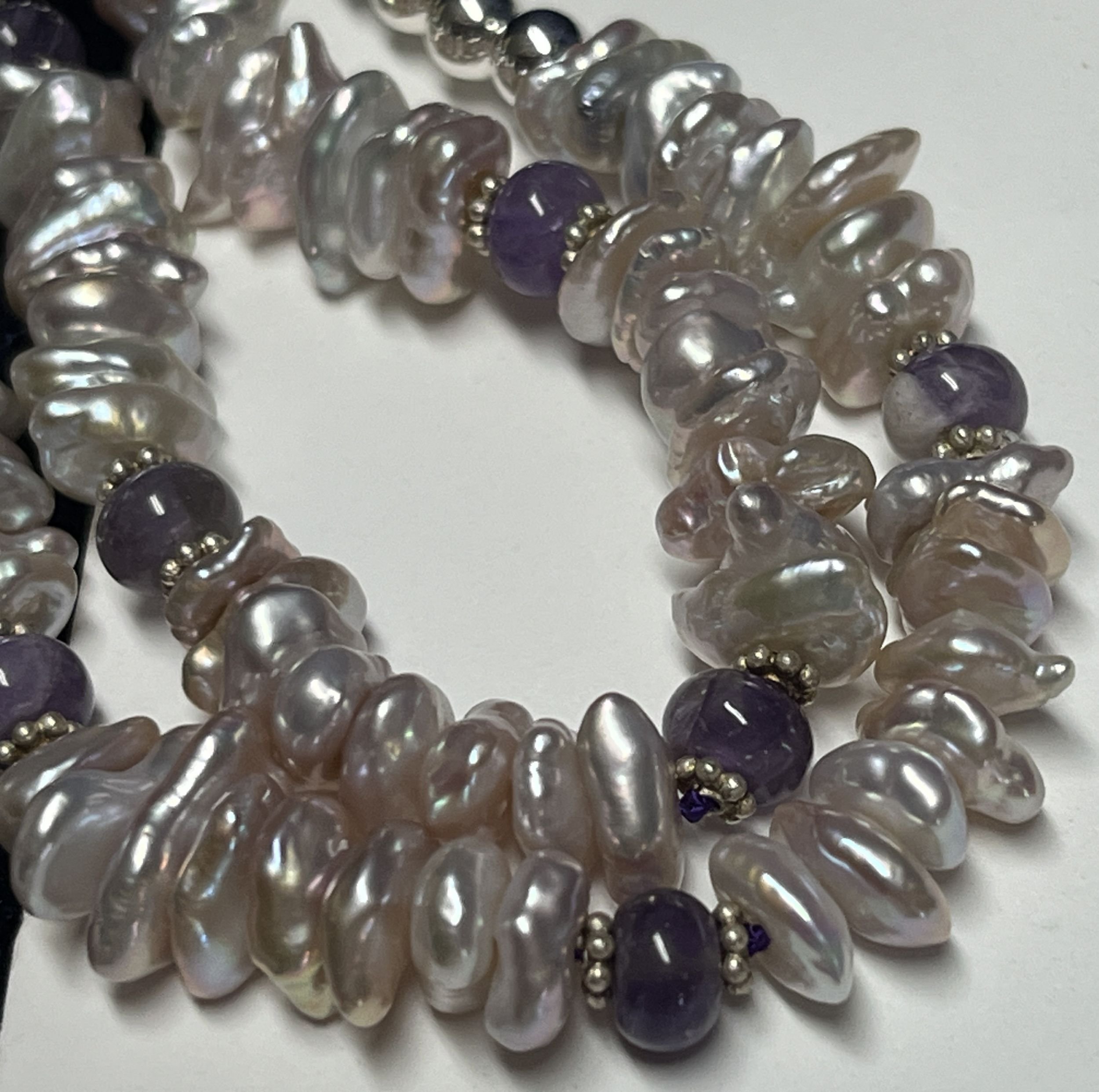 Necklace laying on a white background.