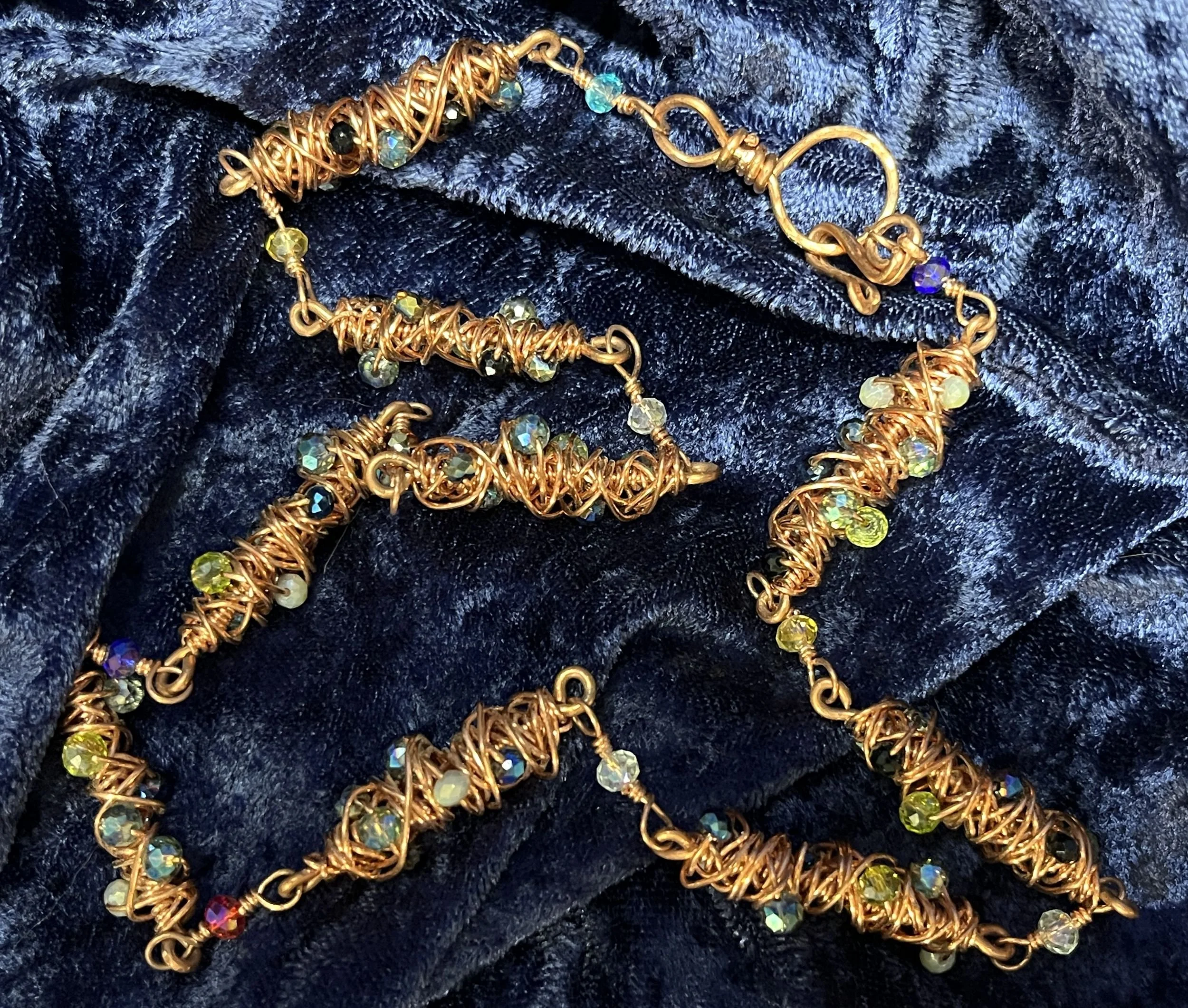 Necklace laying on a blue background.