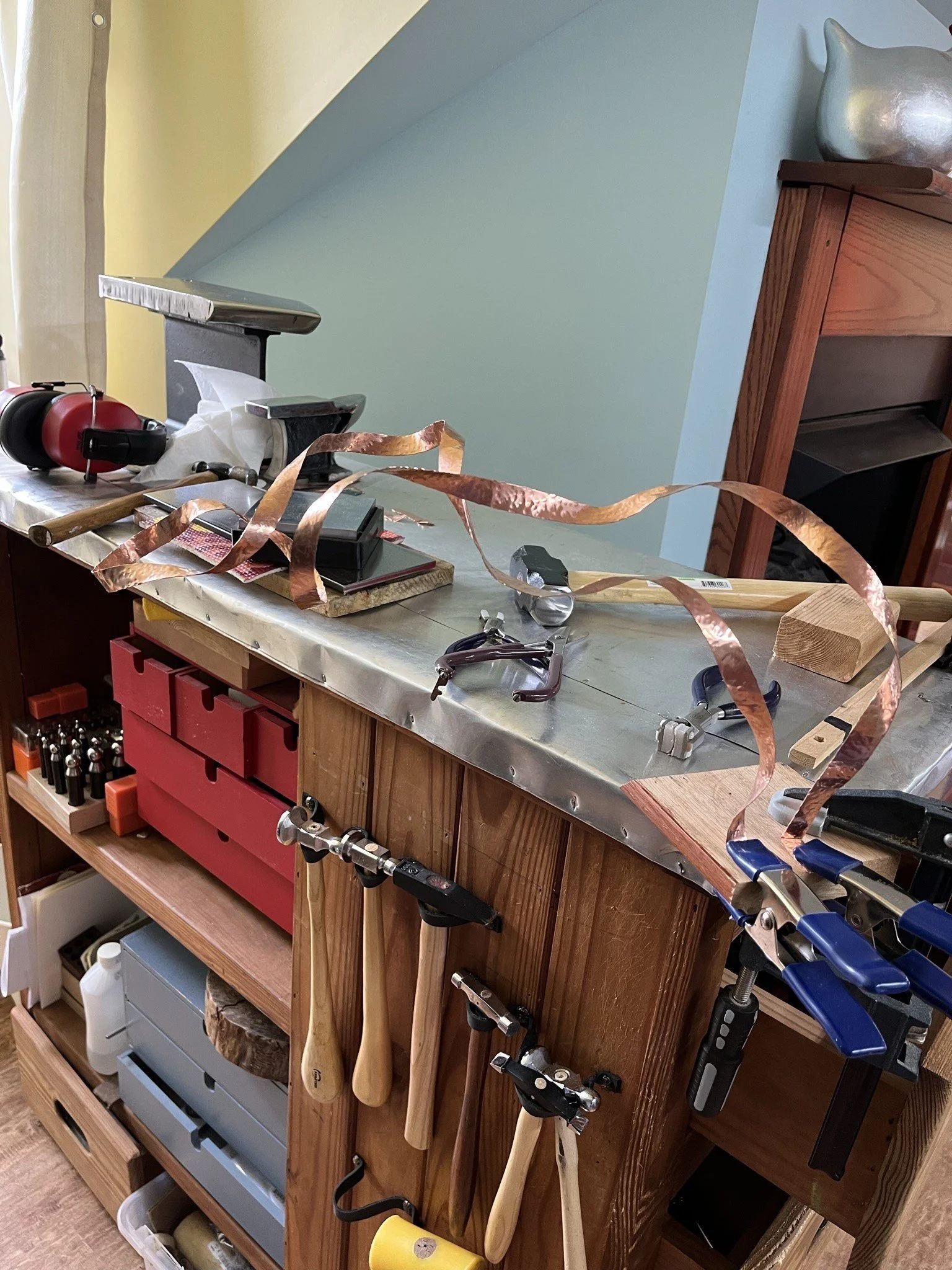 The work bench in the studio is getting a workout with copper and tools sprawled all over it. Hammers hanging off it's side. It is a workhorse.