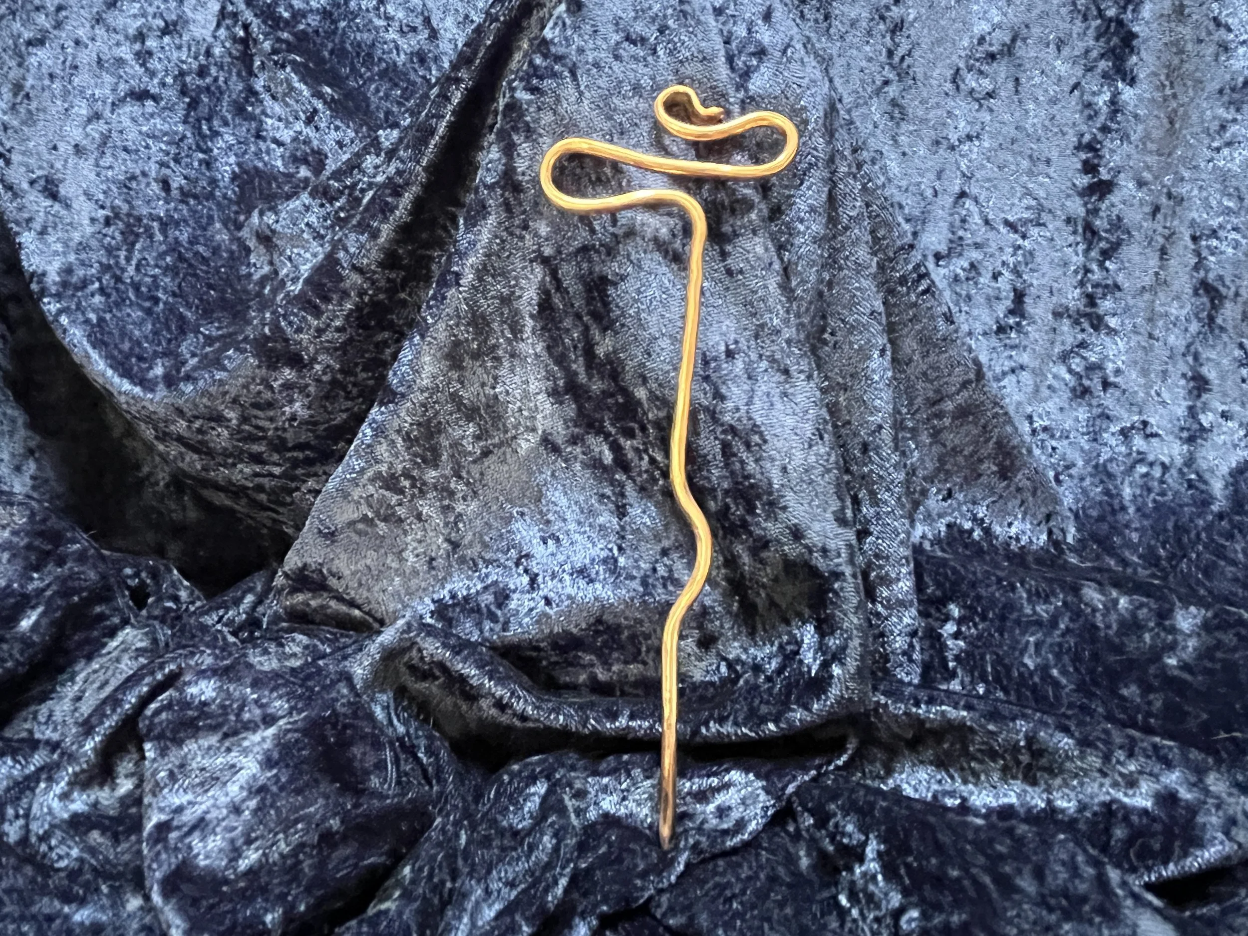 Hair stick laying on a blue background.