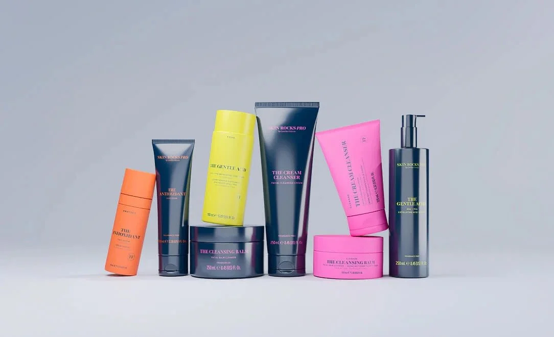 Skin Rocks Pro products including cleansers and acids arranged on a plain light gray background.