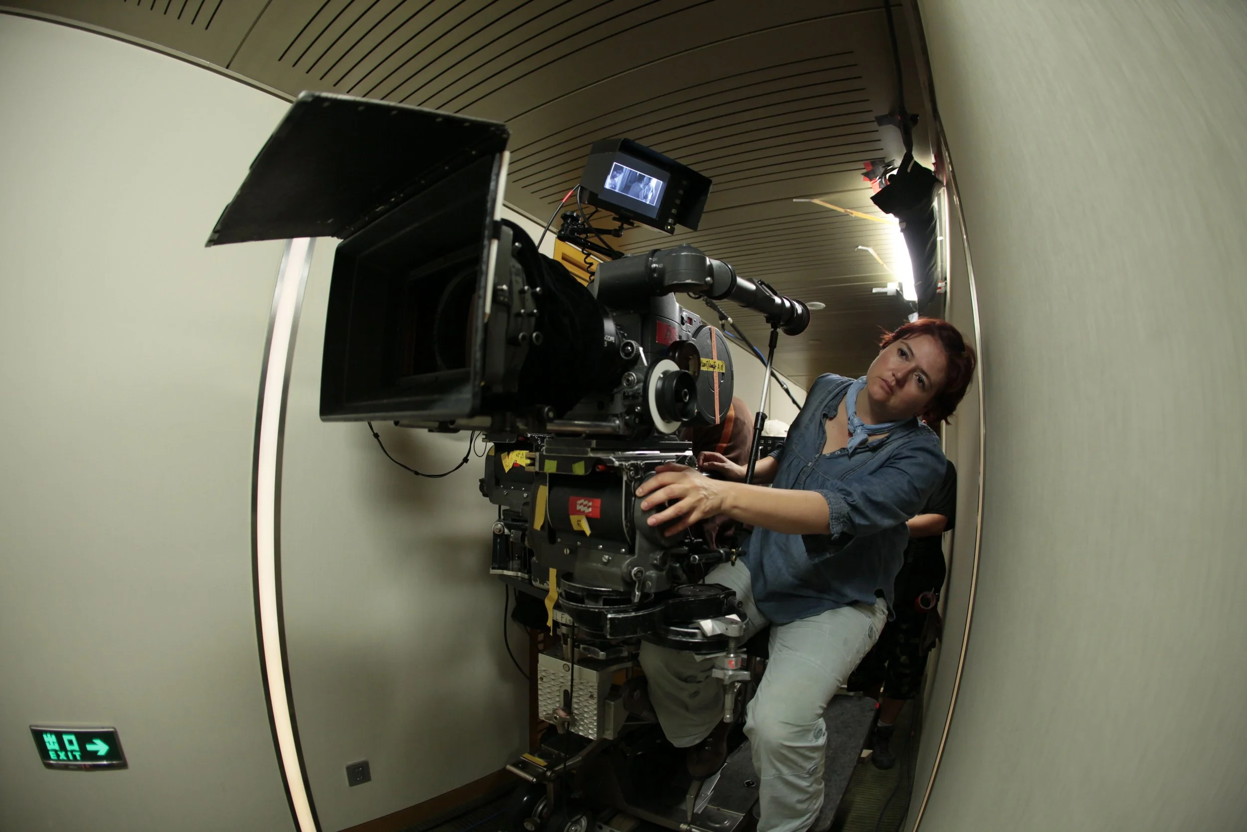 Female Cinematographer Hilda Mercado, AMC operating a film camera on location shooting a feature film in China