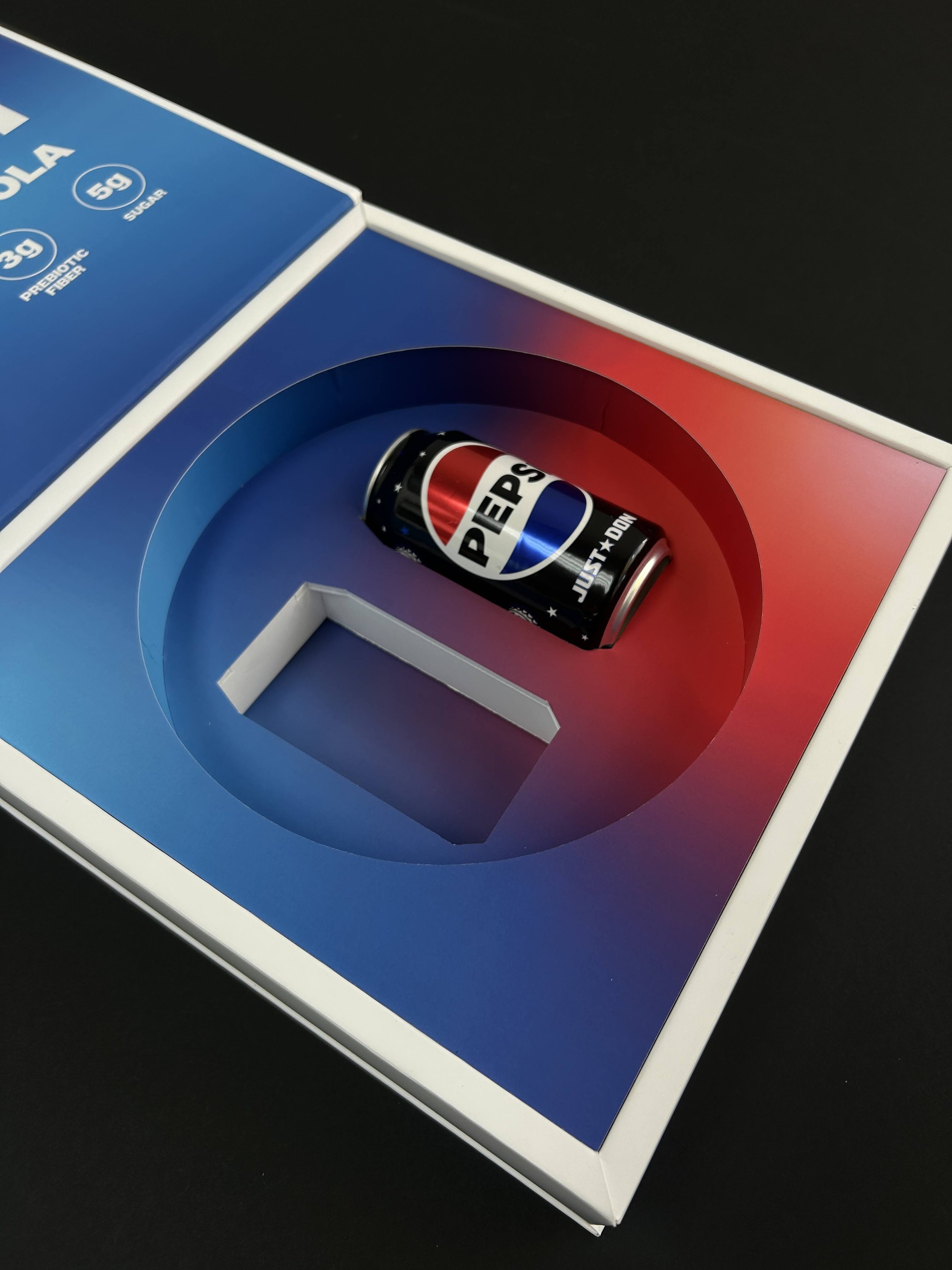 Close-up of a vintage Pepsi soda can on a colorful background with red, white, and blue color scheme.