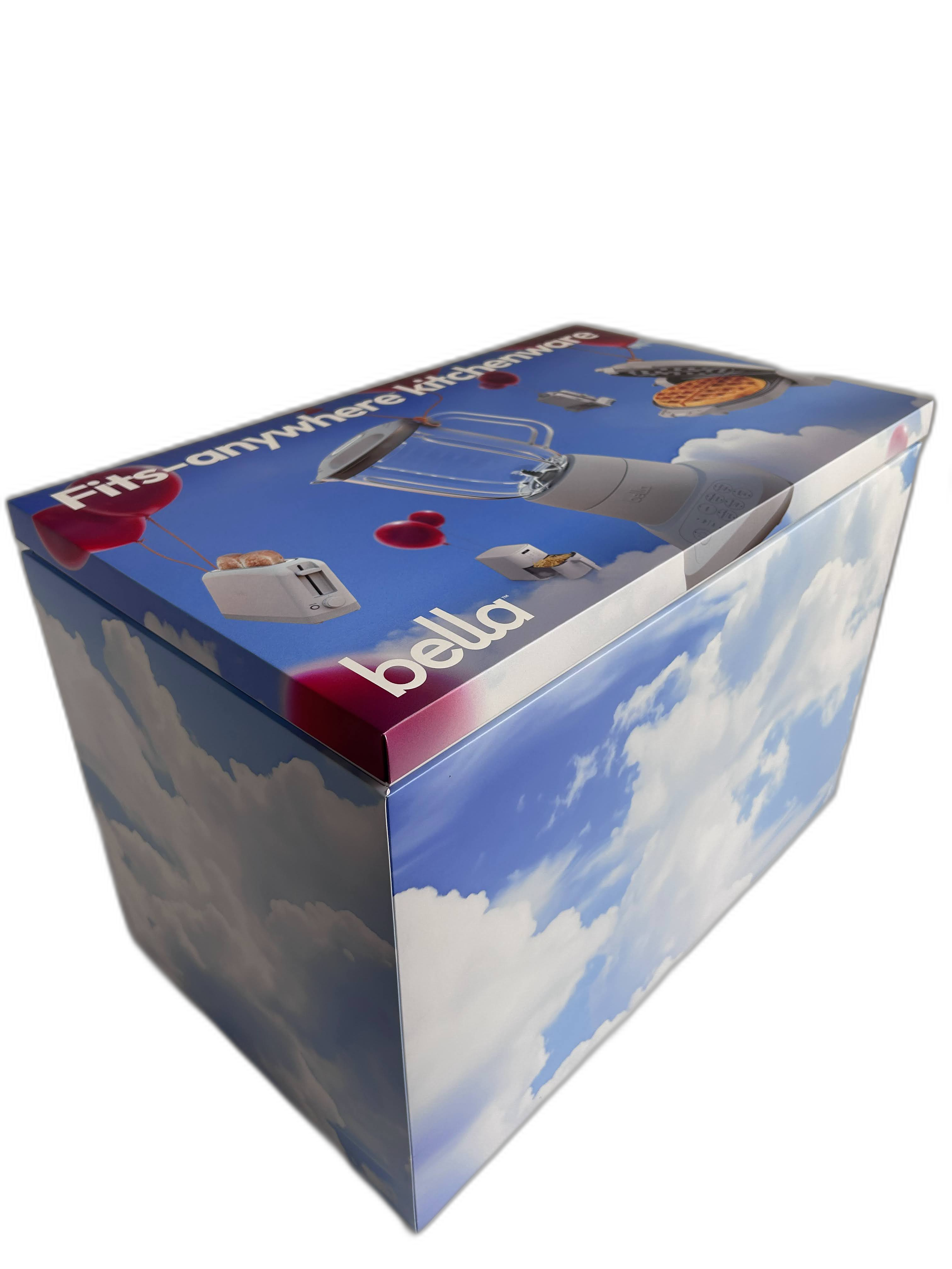 A boxed kitchen blender with a cloud sky design on the packaging, featuring images of toast, a cherry, and balloons.