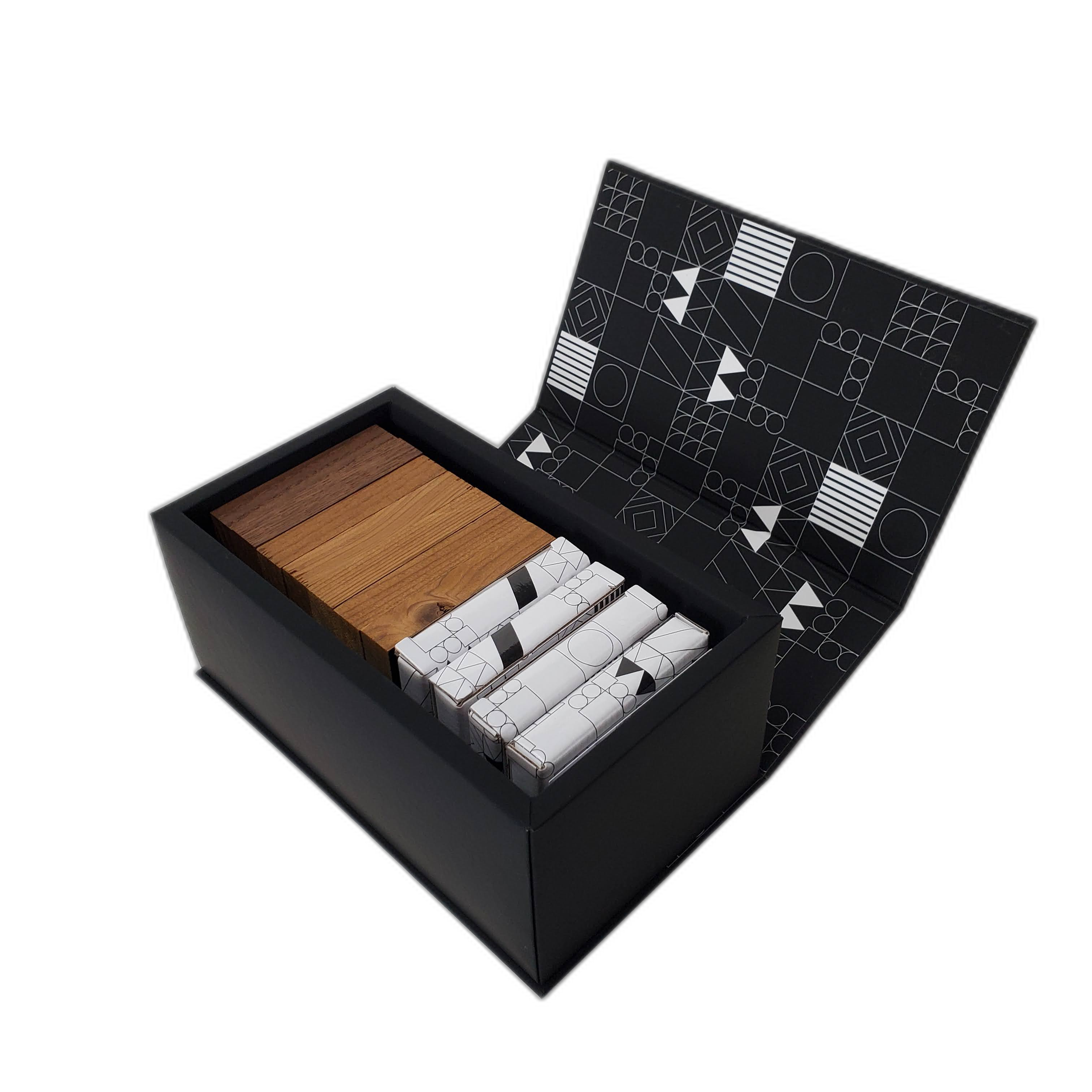 A box containing wood veneer sample swatches and a black box with geometric pattern design on its surface.