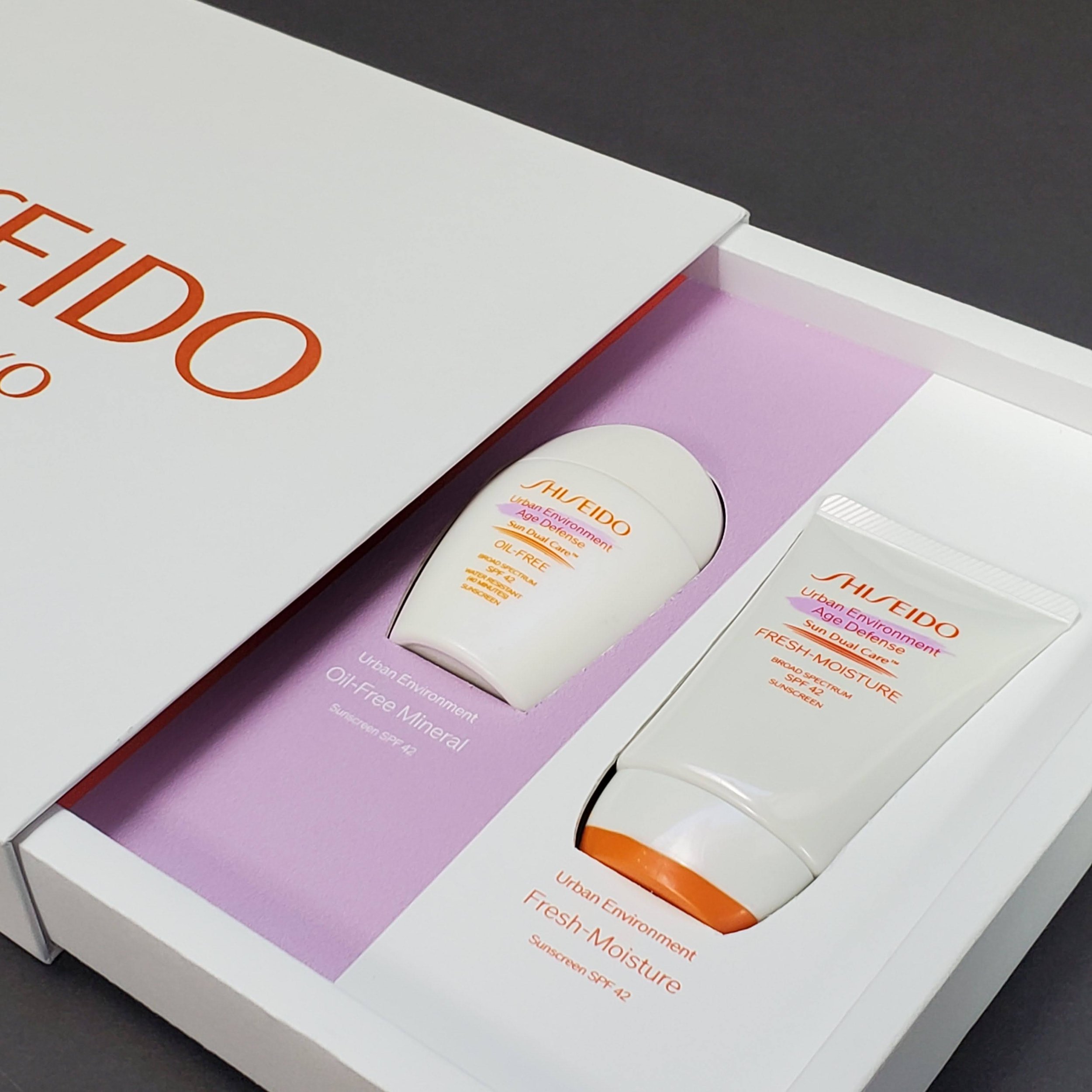 Close-up of skincare product packaging for a whitening moisturizer with SPF 42, featuring purple, white, and orange colors, on a dark surface.