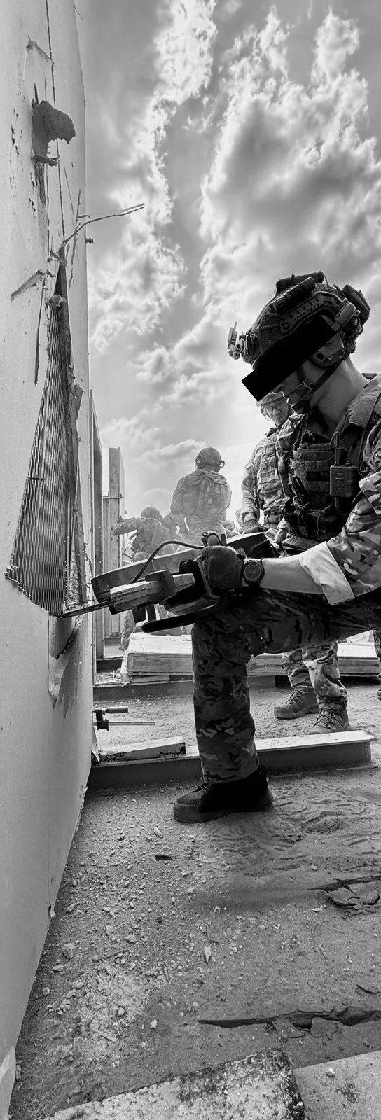 special operators conducting mechanical breaching using a saw