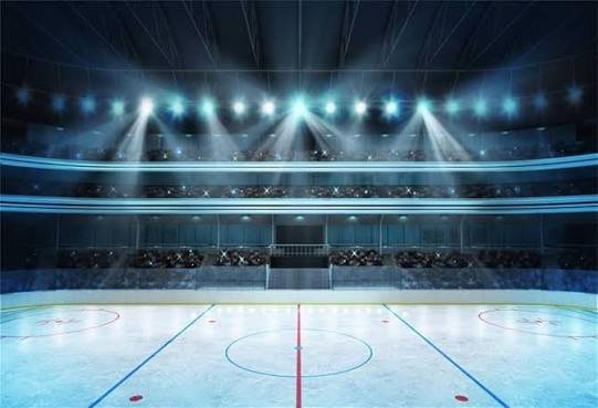 Empty indoor ice hockey rink with bright overhead lights and seating area in background.